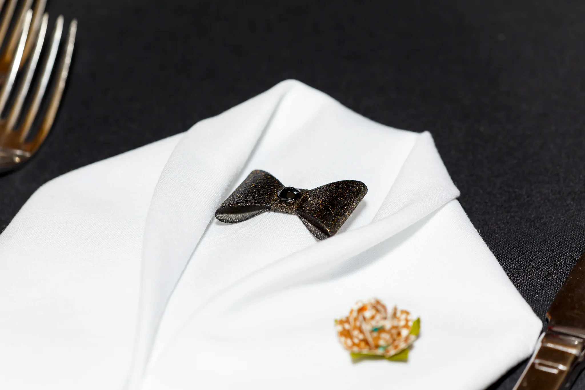 napkins on the tables had black bow ties with a flower detail