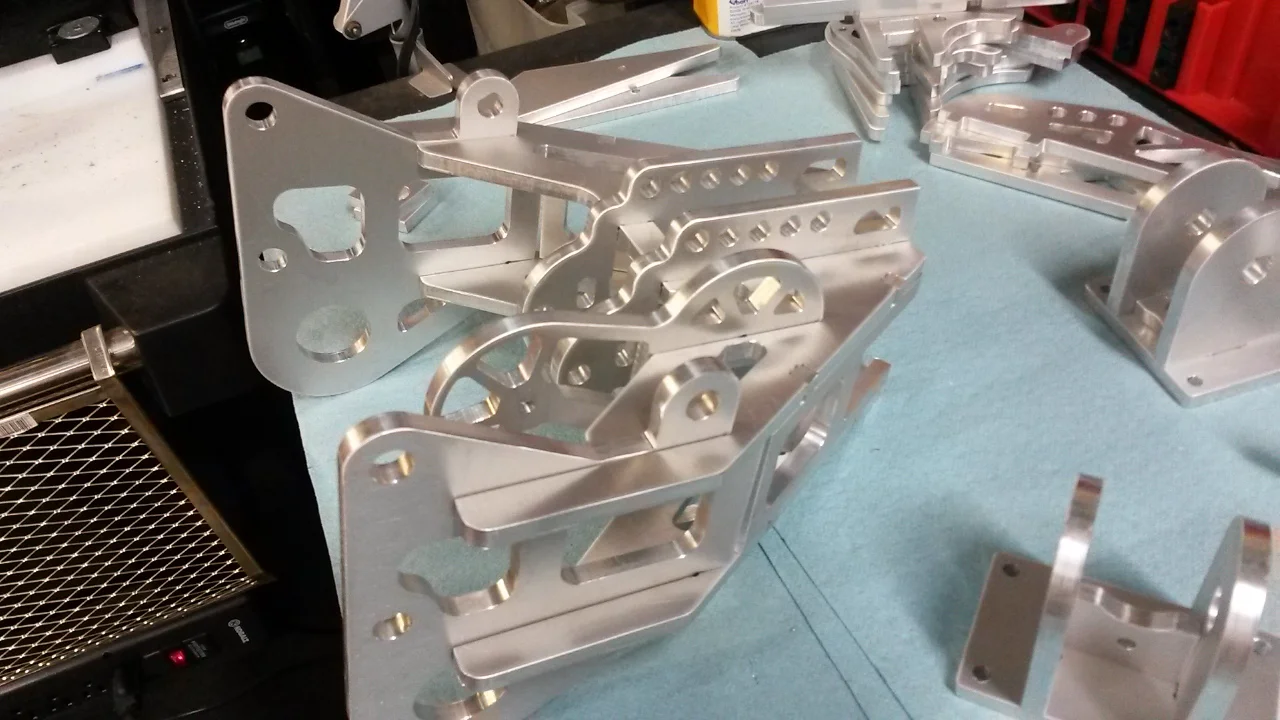 Aluminum plate designed for tab and notch assembly, this pre-assembly is positioned by hand ready to be welded.