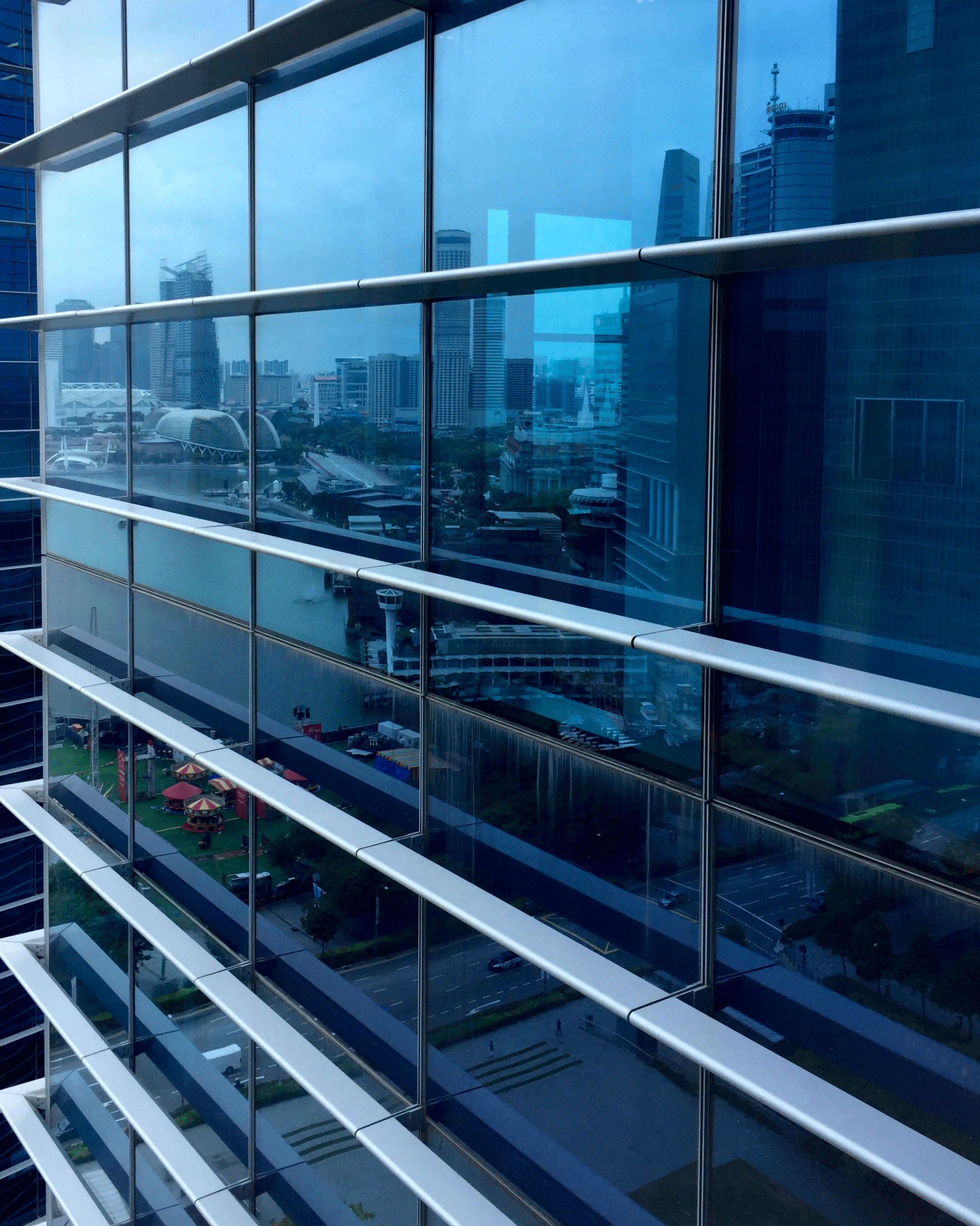 City View © Sean Ginnane, iPhone 6 Here we have a reverse view of the city reflected in the windows of the adjacent buidling. Not only is it a wonderfully abstract/ architectural image, when we look closely we can see details of the city and possibly identify the context.