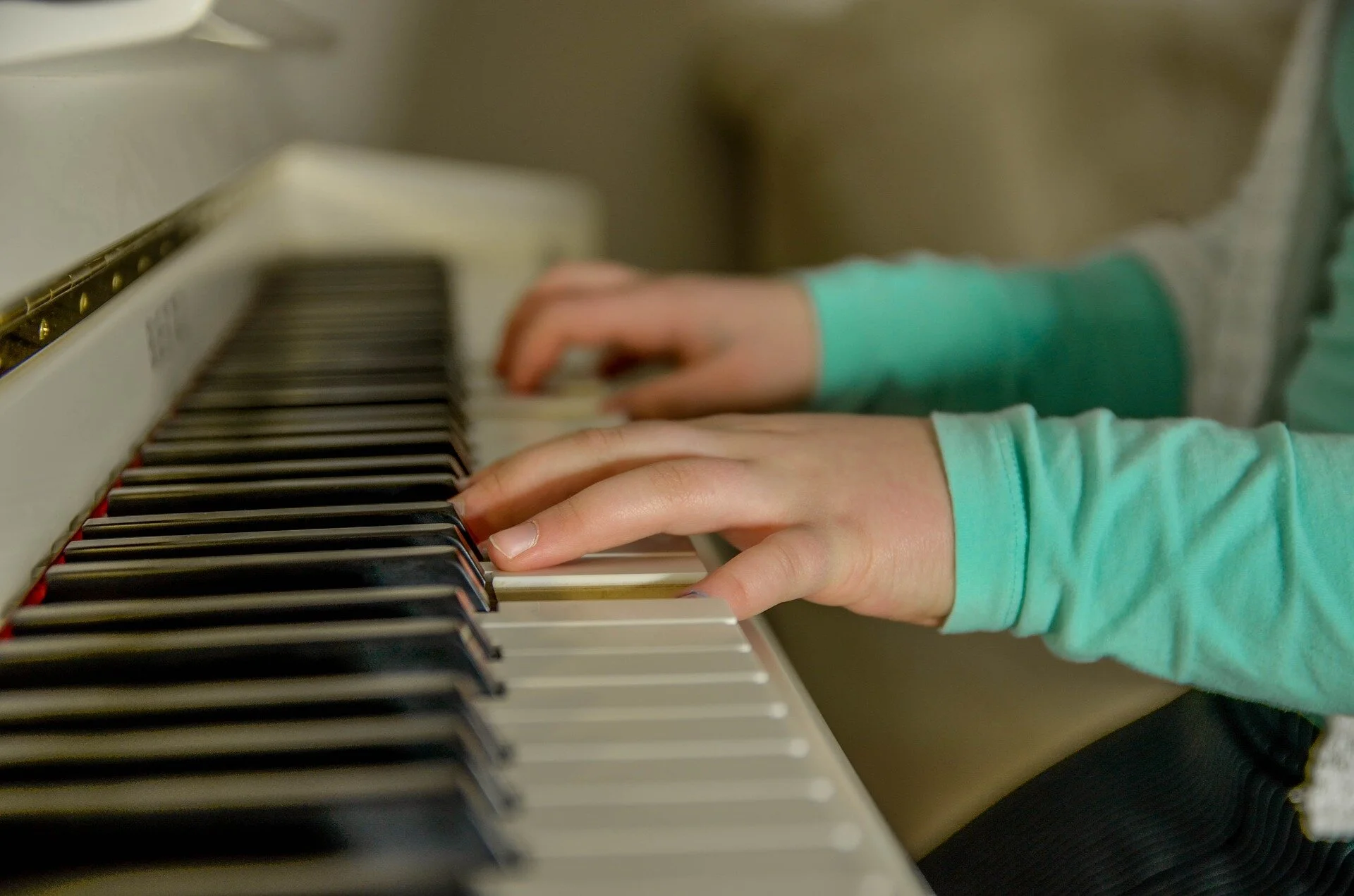 A child's hands playing the piano