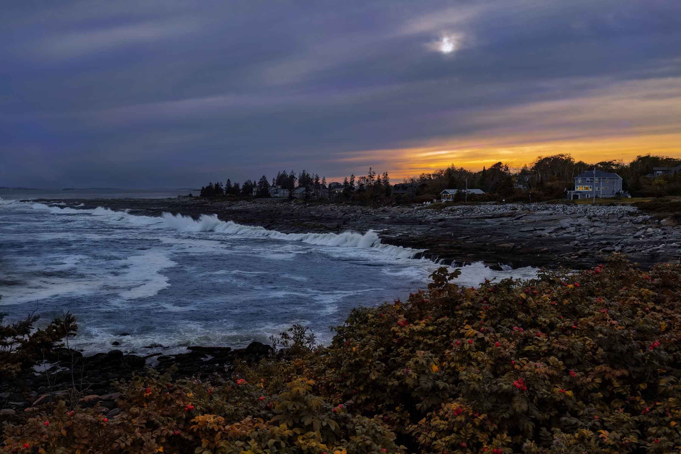 Rough Maine coastal waves pounding a rocky shoreline just before blue hour, captured as dramatic fine art photography for buyers seeking Maine coast prints, nautical wall art, and rugged seaside scenes.