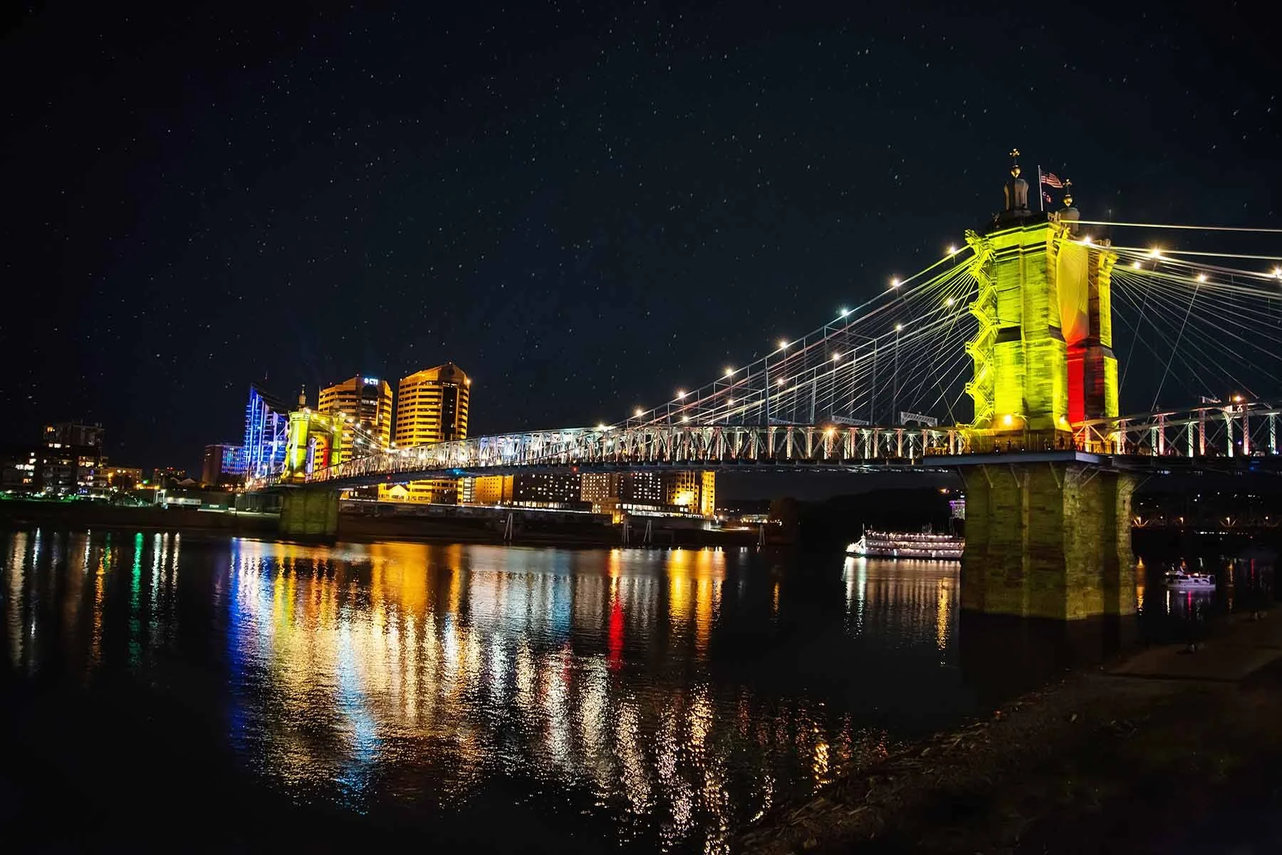Nighttime photo of the John A. Roebling Bridge glowing in yellow Blink Cincinnati lights, captured as fine art wall print by Cincinnati photographer Ed Taylor