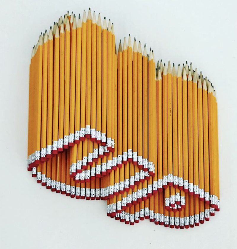 up made from yellow HB hexagon pencils sculpture.png