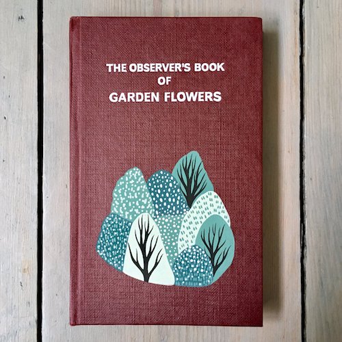 cute customised vintage book cover on garden flowers