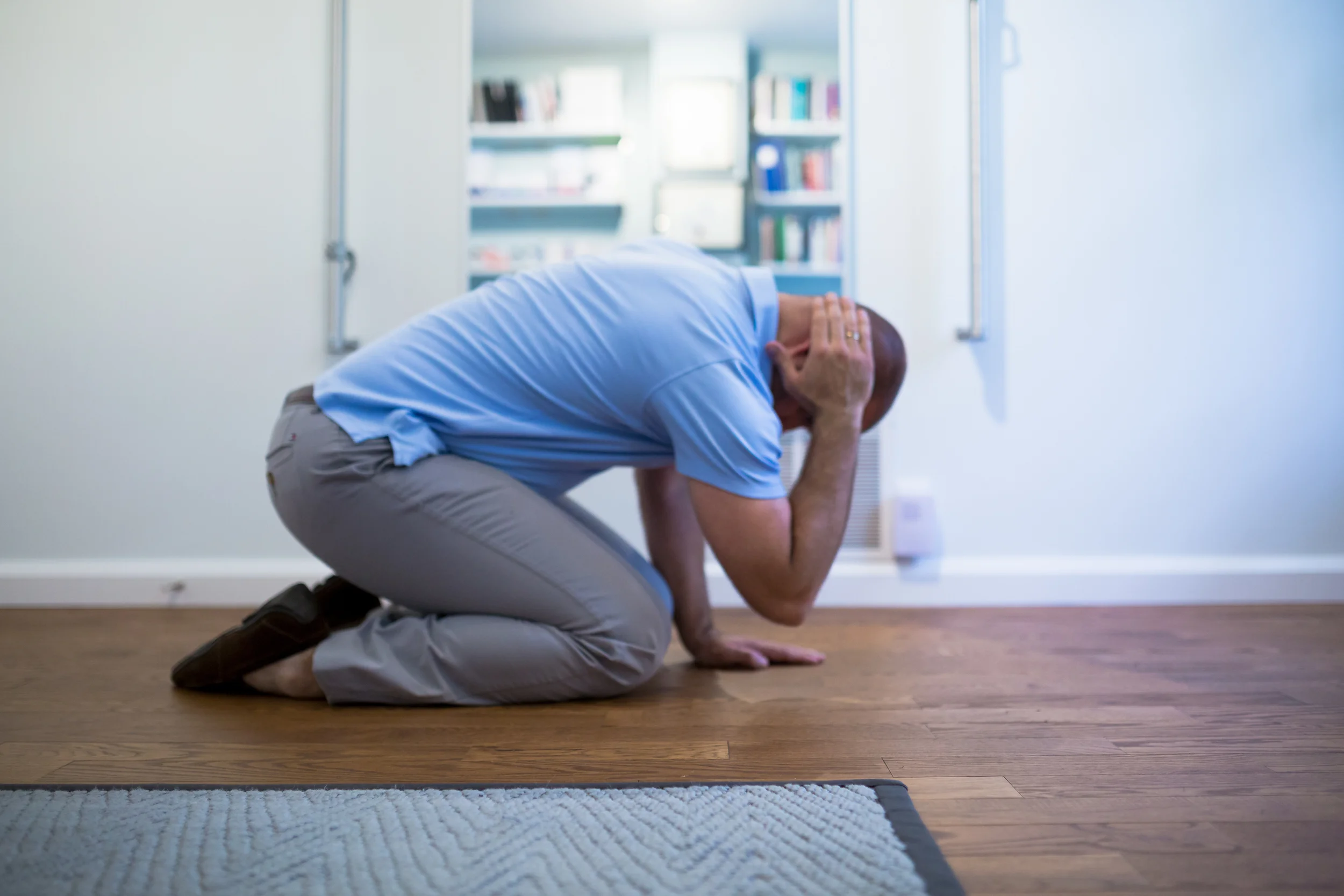 STEP 2: Take your right arm off the floor and gently place your hand behind your ear. Make sure you keep your weight evenly distributed between your legs and your left hand on the floor. Take a breath, inhale and then as you exhale begin moving towards Step 3.