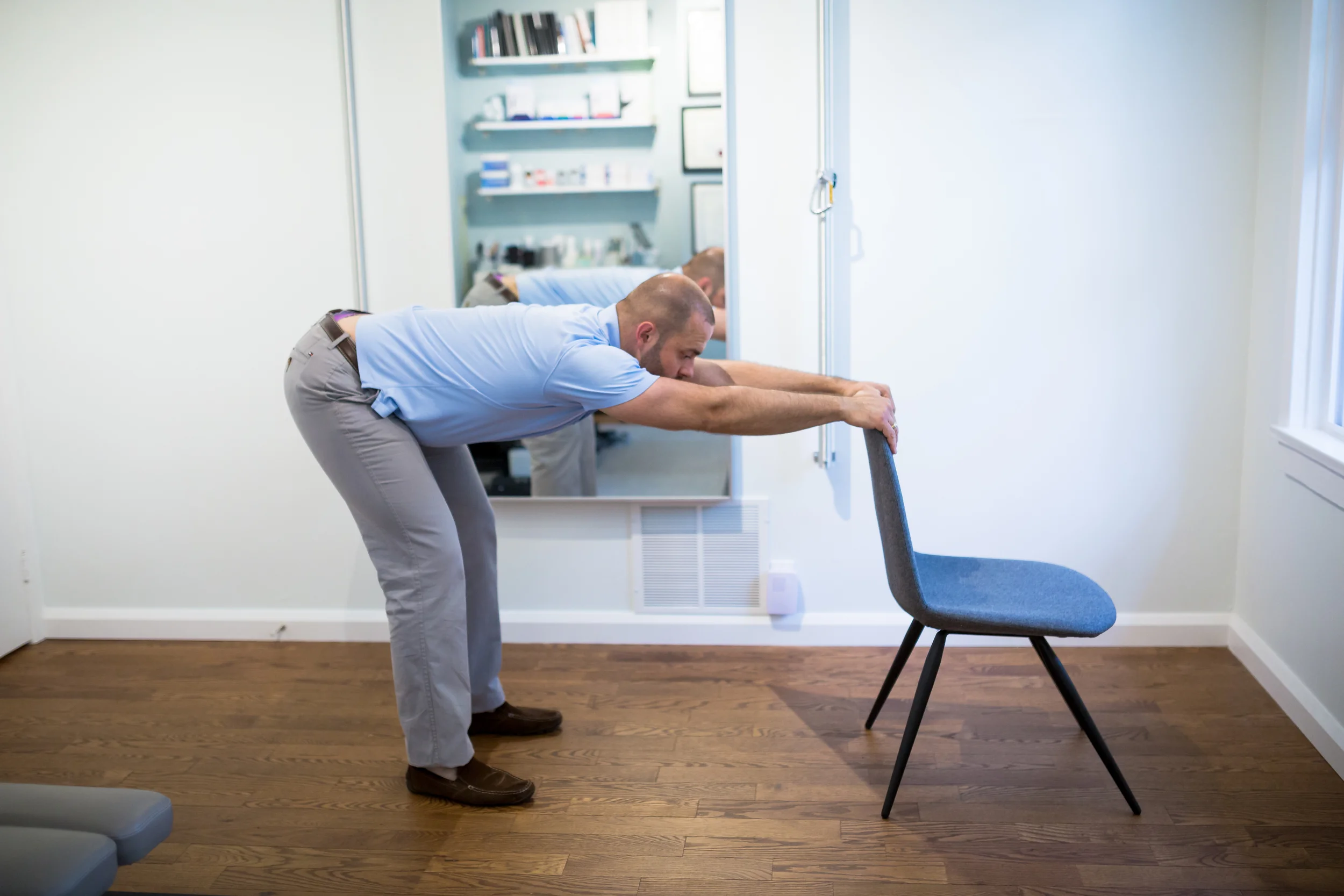 STEP 2: Make sure your feet are pointing forward. Bend your knees and straighten your back so that you are parallel with the floor. Do not pull on the chair. 