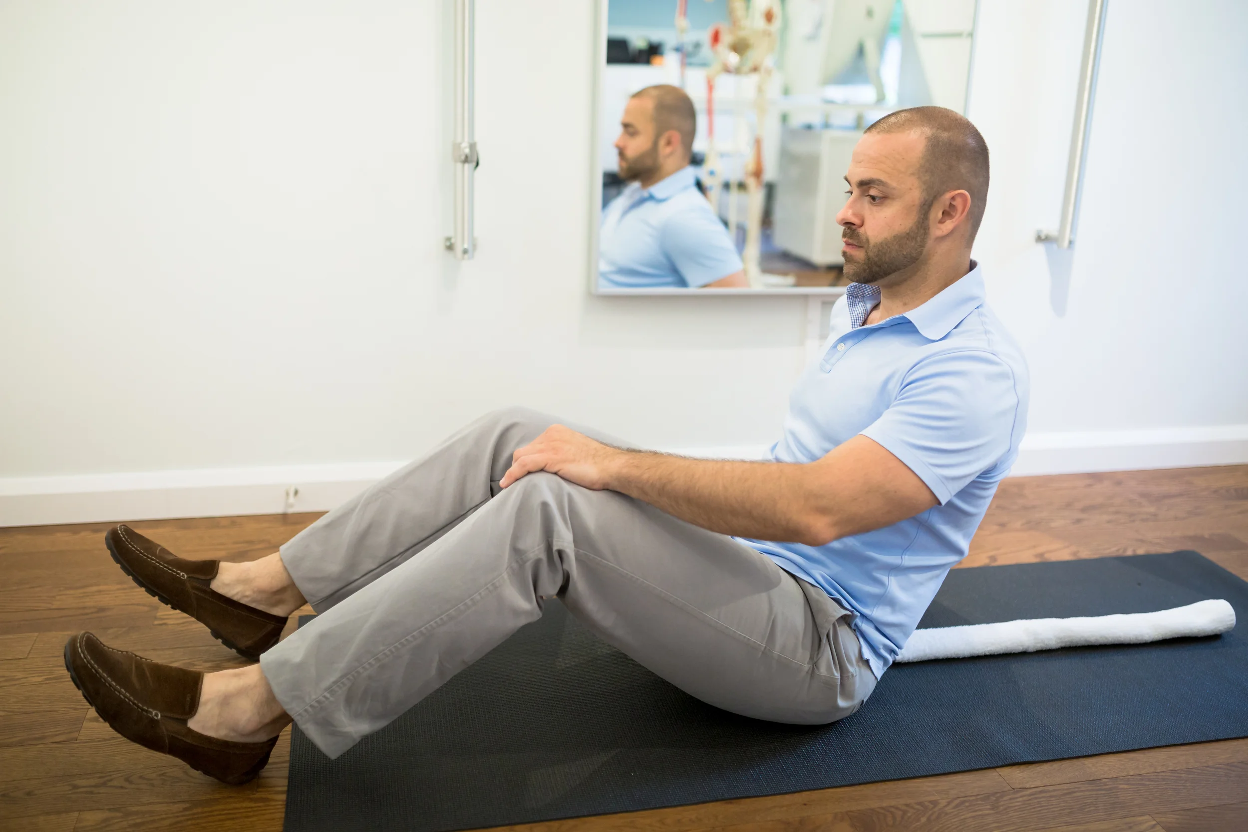 STEP 1: Lay on your back with a towel that has been rolled up (about 2 - 3 inches or 5 - 7 cm) and placed along the spine. Try and keep the head on the floor.