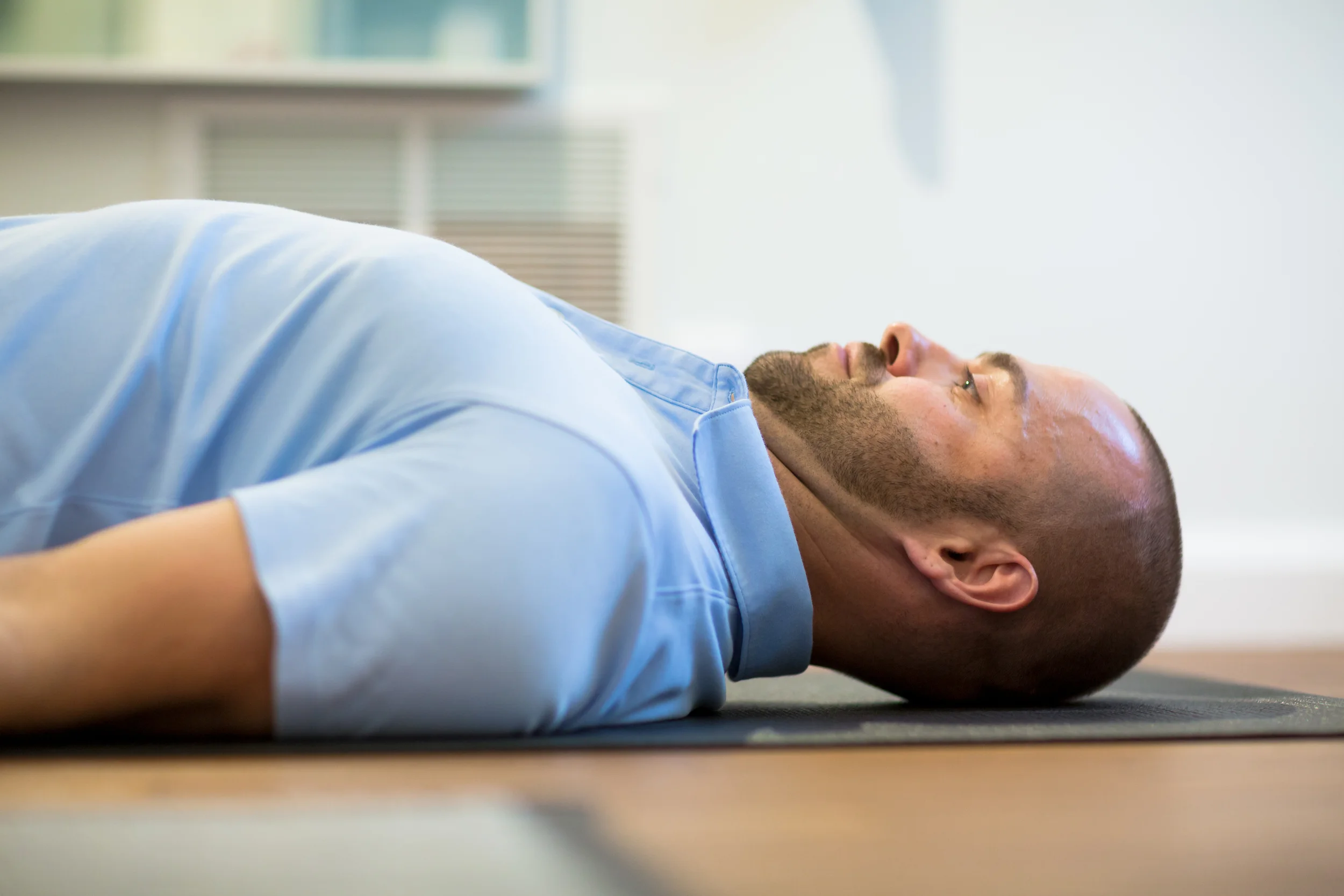 STEP 3: While keeping your tongue pressed against the roof of you mouth, tuck your chin inward without lifting your head off the table. Think of the back of your head being pulled up by a rope.