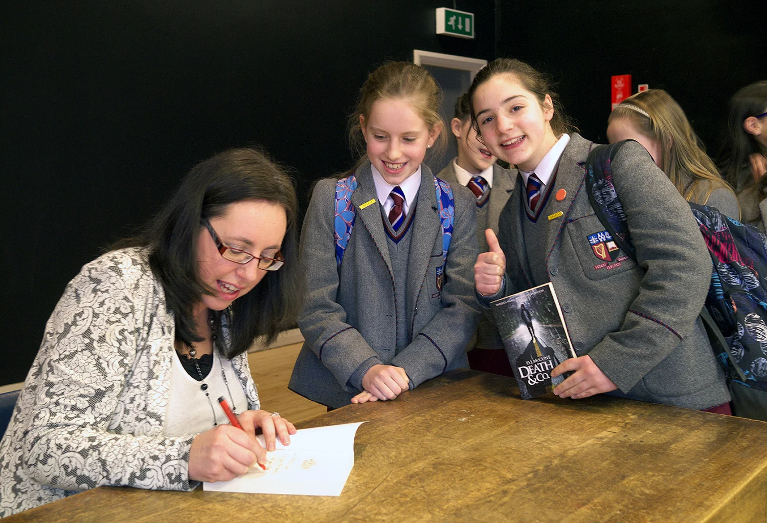 Normal
0
false
false
false
EN-GB
X-NONE
X-NONE
MicrosoftInternetExplorer4
Author D.J. McCune visits Victoria College On Wednesday 29th January the College was delighted to host the author D.J. (Debbie) McCune. Debbie was born in Belfast and grew up in Carrickfergus. After reading Theology at Trinity College, Cambridge, she embarked on a teaching career and has worked for several years at a local integrated college. Having taken a break from teaching, she has now published two highly acclaimed teenage novels – Death and Co. and its sequel The Mortal Knife. After speaking to pupils from Years 8 & 9, Debbie took time to answer some probing questions from the pupils before signing copies of her books. For more details on Debbie and her books see www.hotkeybooks.com/authors/detail/d.-j.-mccune www.twitter.com/debbiemccune www.facebook.com/djmccuneauthor www.tumblr.com/blog/debbiemccune
st1\:*{behavior:url(#ieooui) } /* Style Definitions */
table.MsoNormalTable
{mso-style-name:"Table Normal";
mso-tstyle-rowband-size:0;
mso-tstyle-colband-size:0;
mso-style-noshow:yes;
mso-style-priority:99;
mso-style-qformat:yes;
mso-style-parent:"";
mso-padding-alt:0cm 5.4pt 0cm 5.4pt;
mso-para-margin:0cm;
mso-para-margin-bottom:.0001pt;
mso-pagination:widow-orphan;
font-size:11.0pt;
font-family:"Calibri","sans-serif";
mso-ascii-font-family:Calibri;
mso-ascii-theme-font:minor-latin;
mso-fareast-font-family:Calibri;
mso-fareast-theme-font:minor-latin;
mso-hansi-font-family:Calibri;
mso-hansi-theme-font:minor-latin;
mso-bidi-font-family:"Times New Roman";
mso-bidi-theme-font:minor-bidi;
mso-fareast-language:EN-US;}