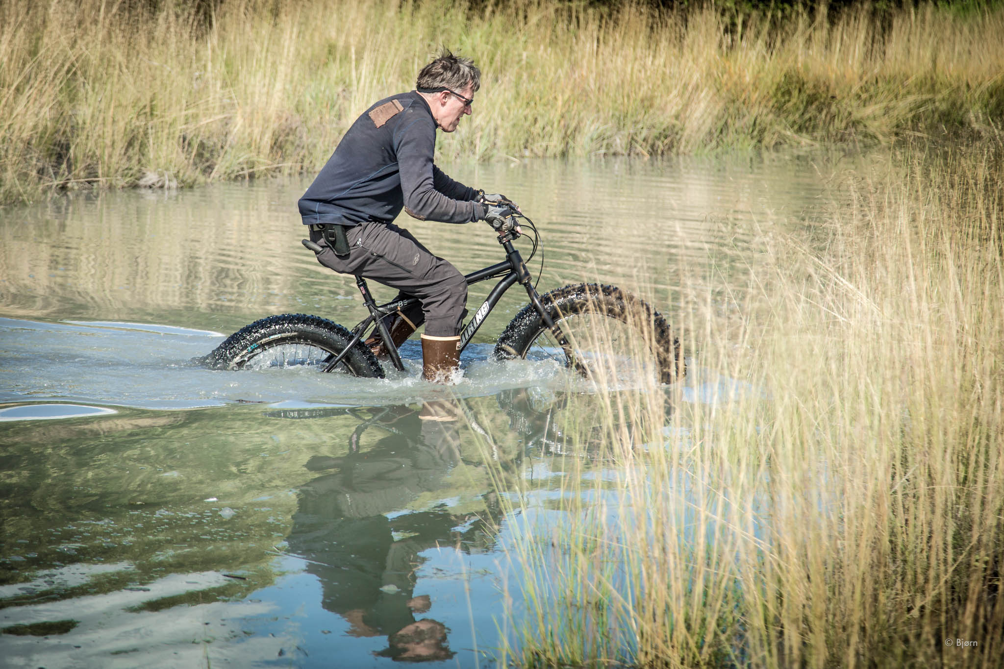  George rides through a deep creek - Seward, Alaska.&nbsp; 