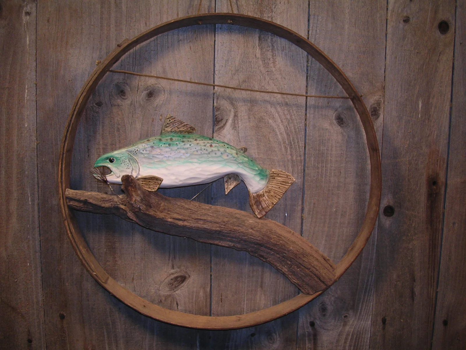 Trout displayed on a old barrel ring
