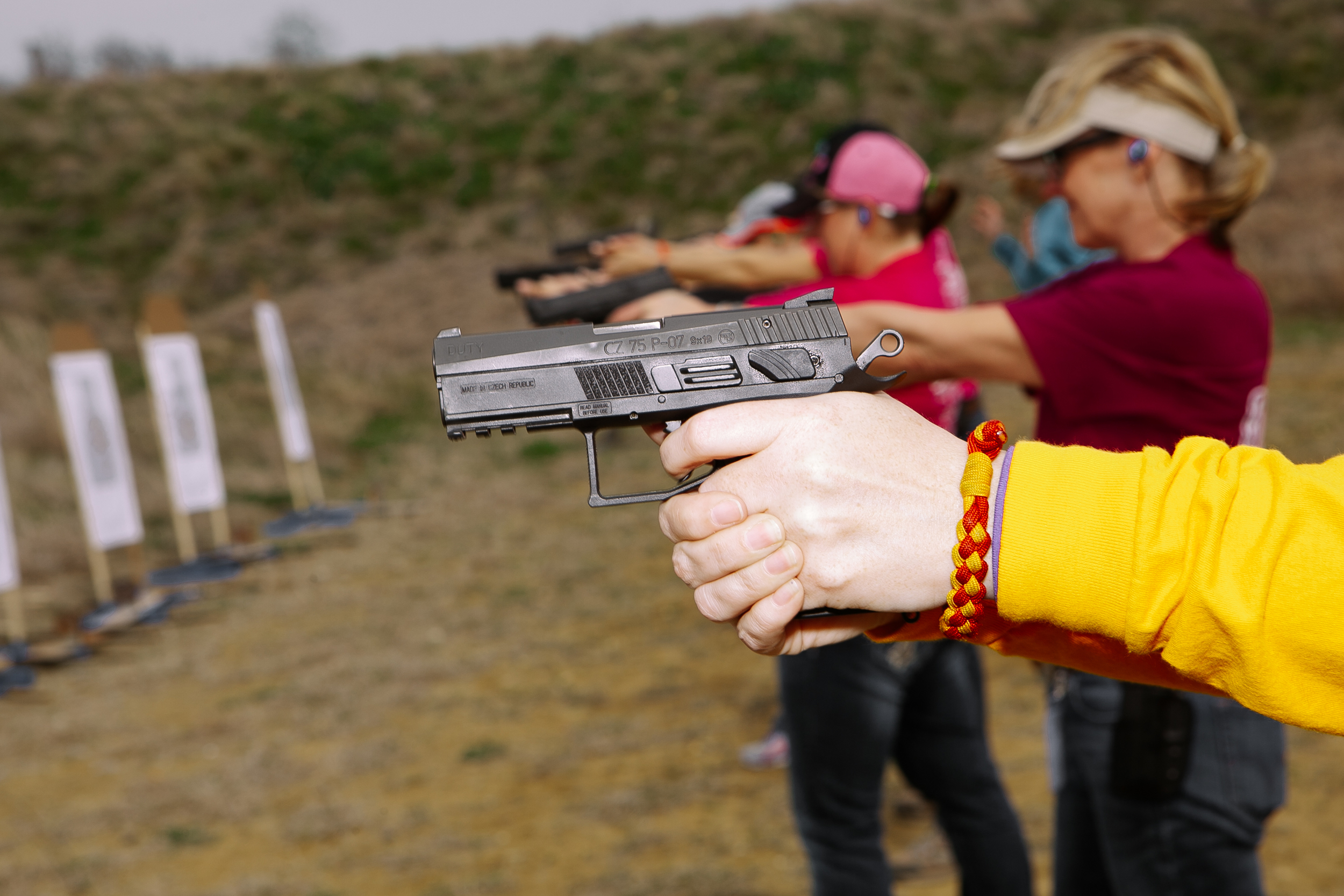 A woman prepares to shoot her gun at an all Women's shooting league convention near Waco, Texas. 