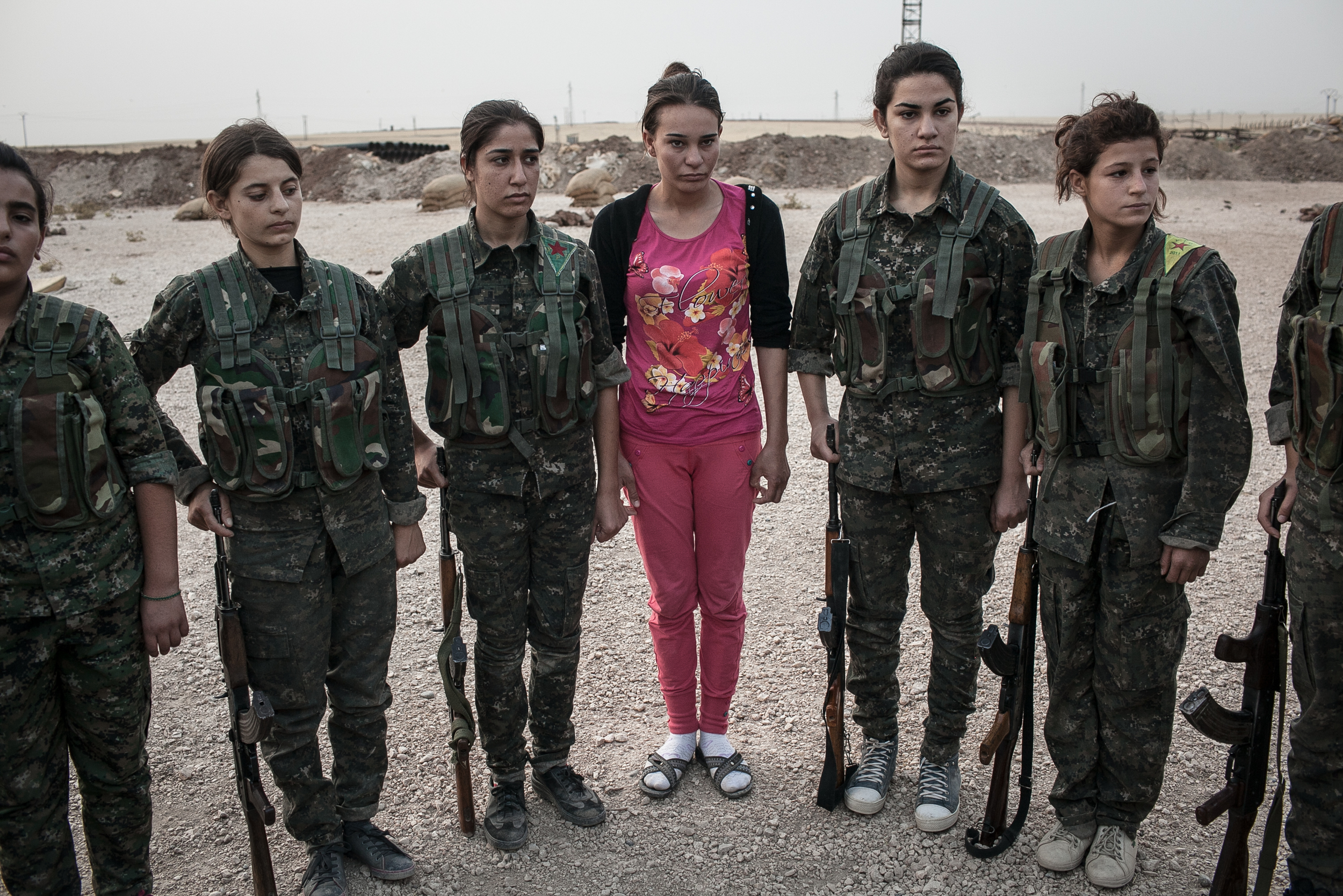  A young YPJ recruit, center, arrives on her first day to the YPJ training base near Derek City, Syria. 