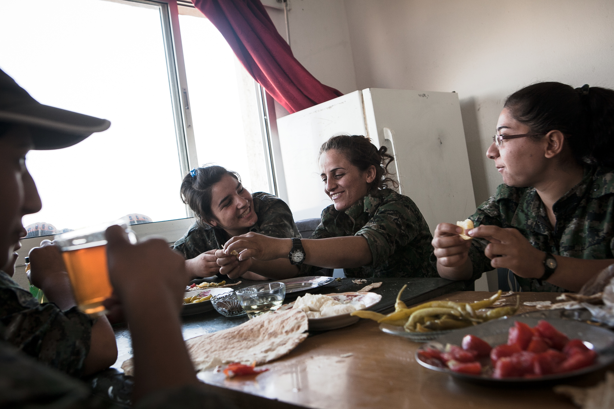  YPJ soldiers have breakfast at their military post near the Syrian-Iraq border in Til Kocer, Syria. YPJ meals are modest since most of their supplies and food are donated from local community members. 