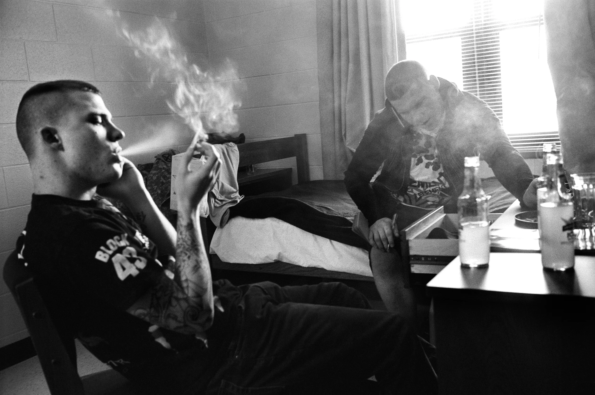 SPC Ryan Cooley and SPC Adam Ramsey smoke cigarettes in the barracks at Fort Drum, New York, 2010.