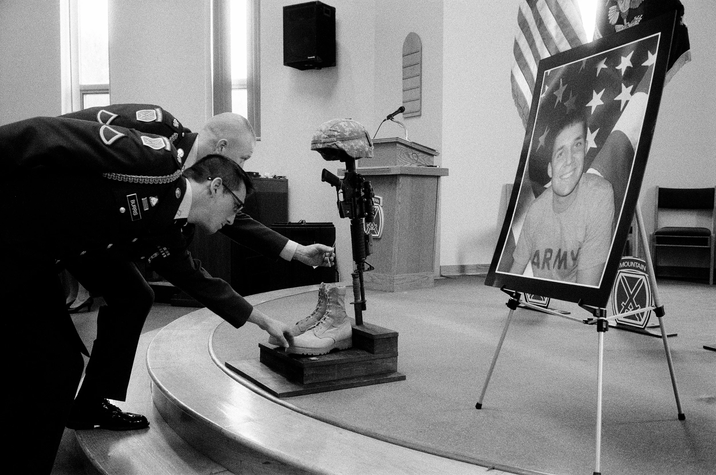 Two soldiers from Alpha Company, 2-87 Infantry Regiment, touch the dog tags of SSG Cody Anderson at his memorial at Fort Drum, New York, 2010. After serving in Afghanistan Anderson was diagnosed with PTSD and bi-polar disorder. On the morning of Jan. 14, 2010, Anderson was found dead in his apartment. Although the Watertown newspaper first claimed his death was an "unknown suicide," police later stated that Anderson died of acute pneumonia. It is unclear whether Anderson's death was also related to the medications prescribed to him by Fort Drum's Behavioral Health Department.