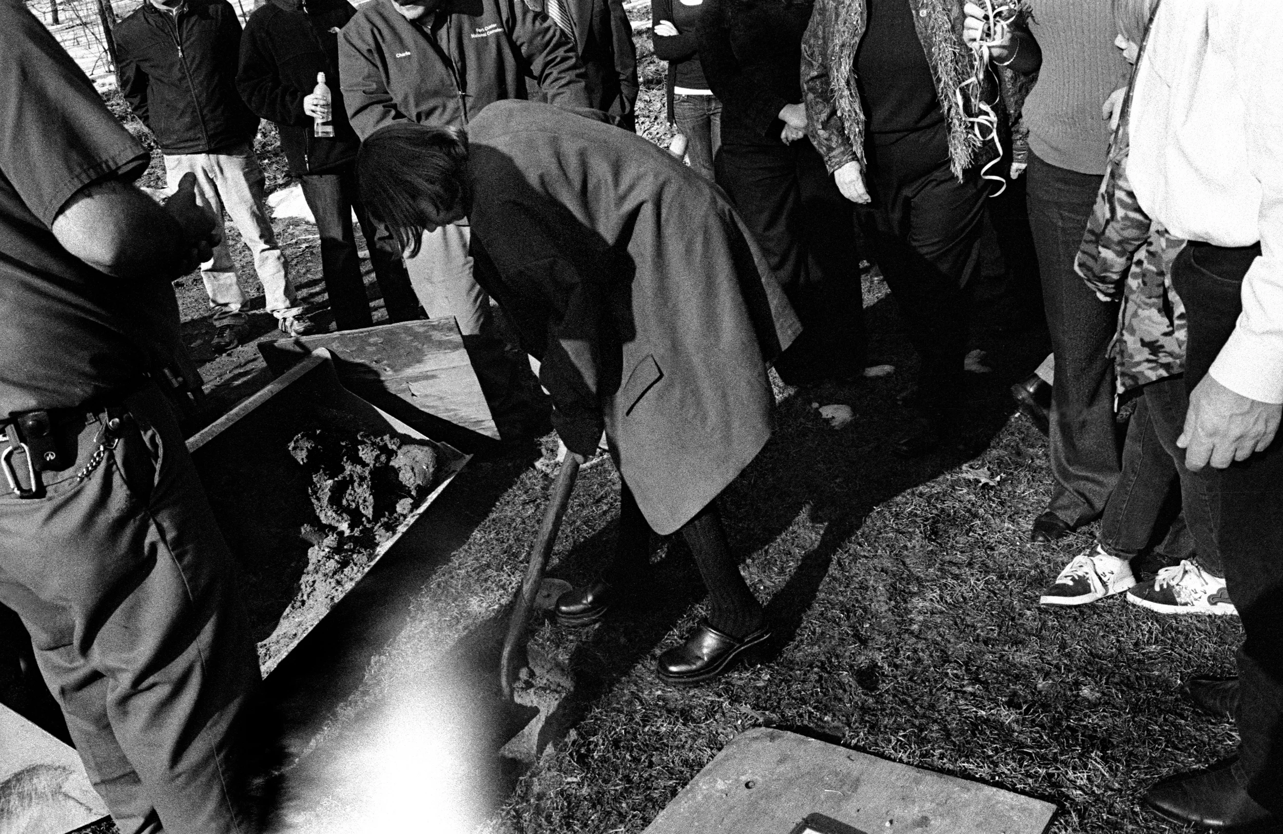 Family members shovel dirt over the ashes of SPC Dirk Terpstra at Ft. Custer National Cemetery in Augusta, Michigan, 2010.