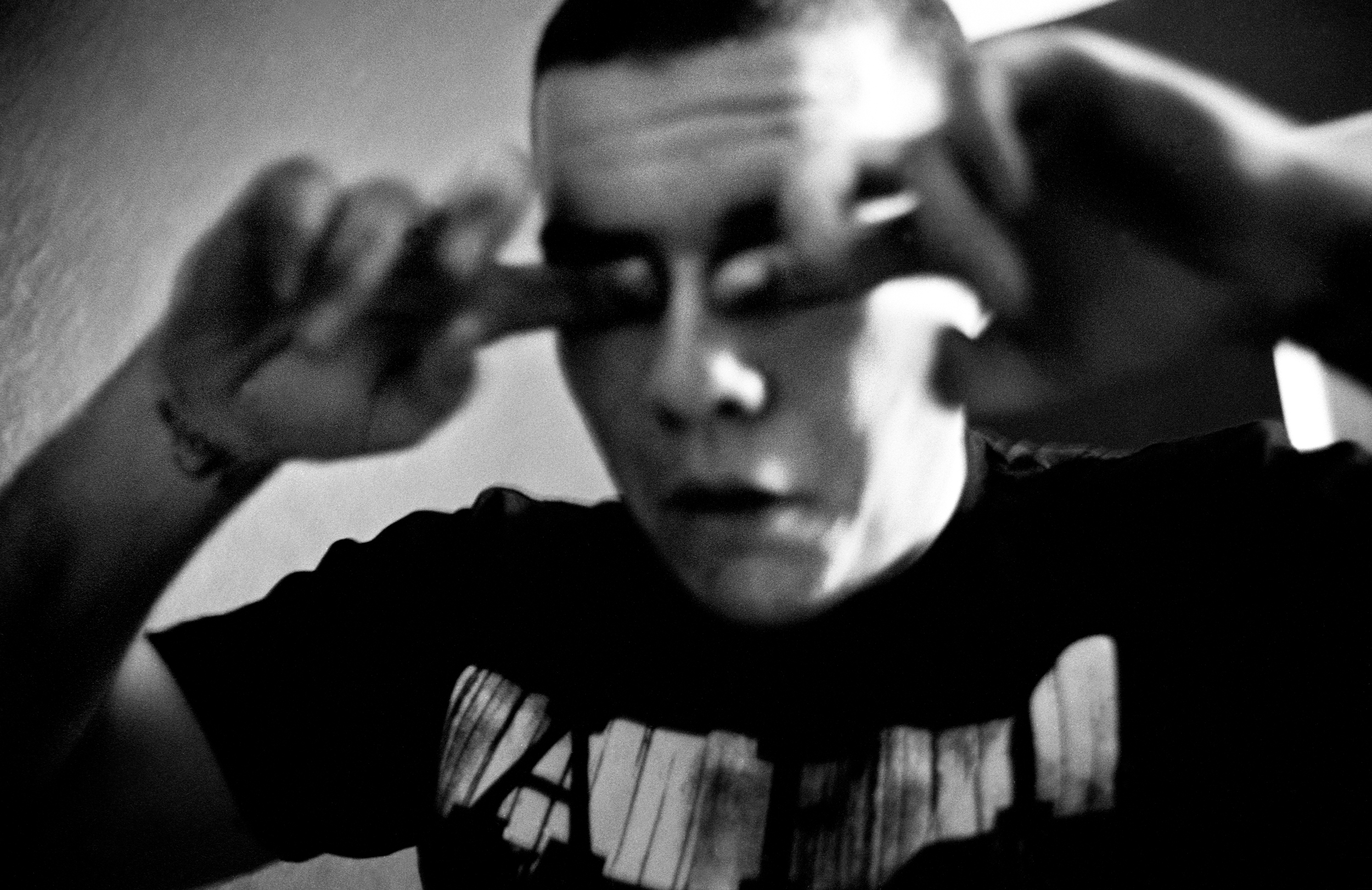  SPC Adam Ramsey rubs his eyes after having an anxiety attack at his sister's house in Carson City, Nevada, 2010. While on leave in Nevada Ramsey experienced hallucinations, depression, and suicidal thoughts; he self-medicated by mixing prescribed me