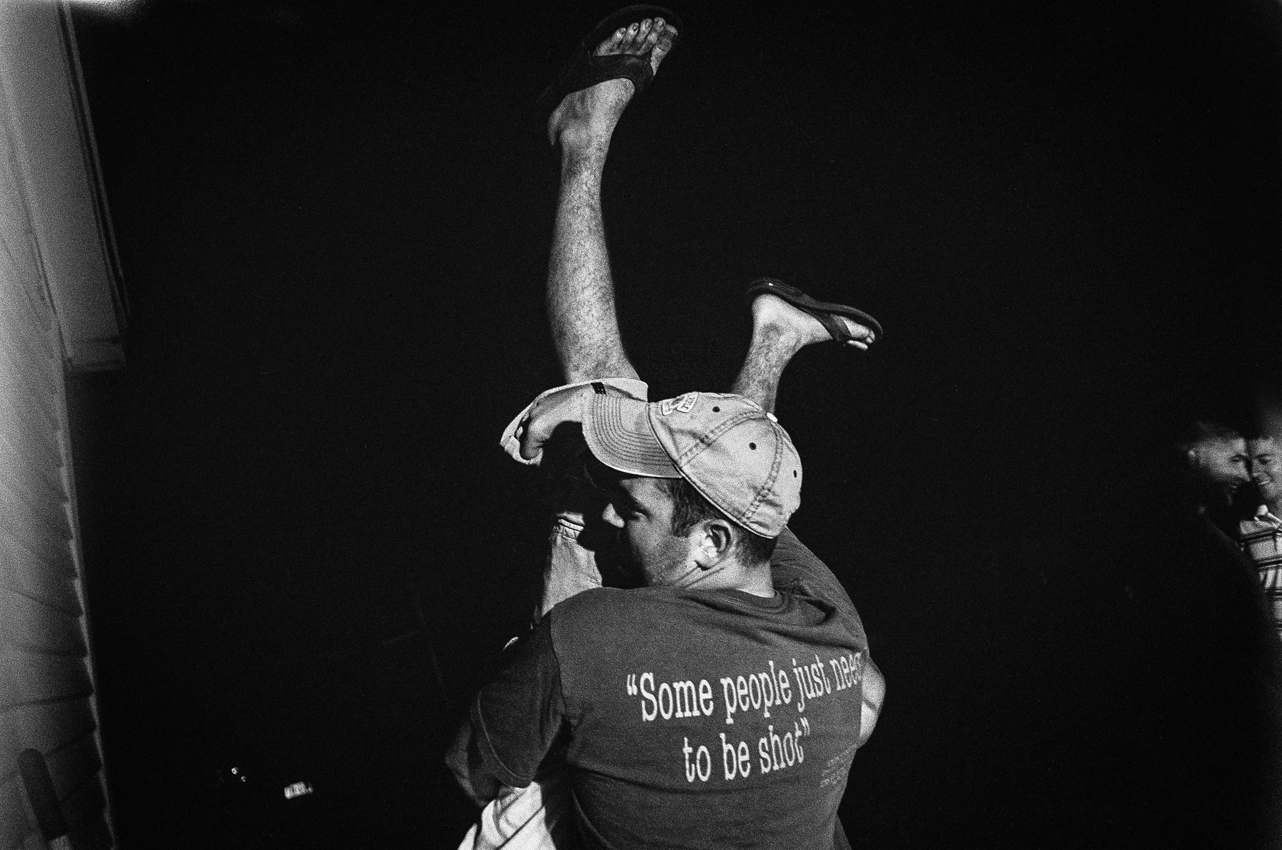 A soldier lifts SGT James Nunley to do a keg stand at a party in Watertown, New York, 2010.