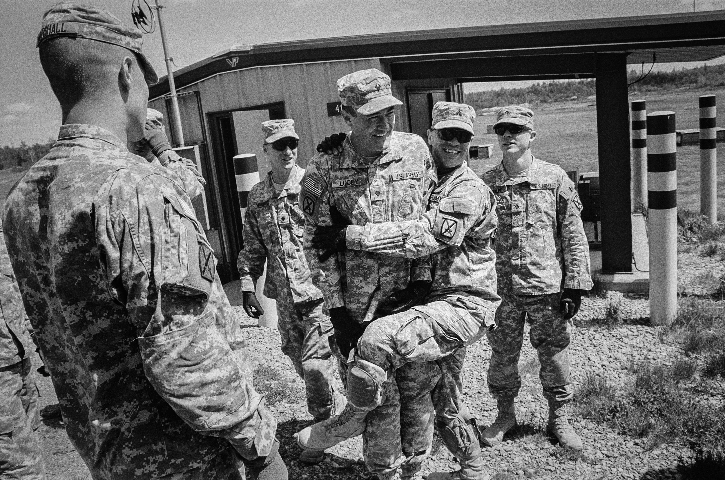 SPC Brian Lucy is hugged by a fellow soldier during training drills at Fort Drum, New York, 2010.