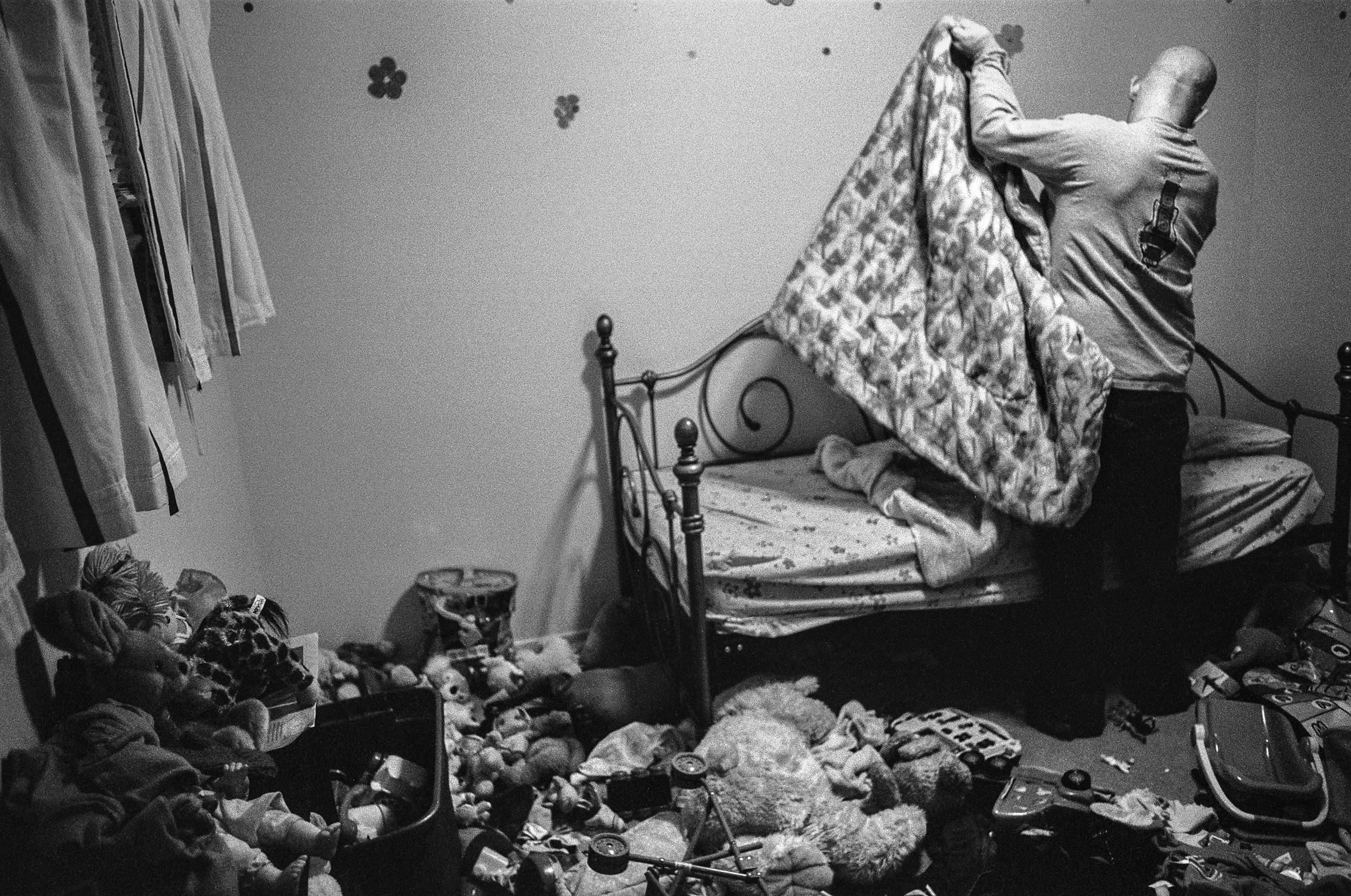 SPC Matthew Ledford tucks his daughter in to bed at Fort Drum, New York, 2011.