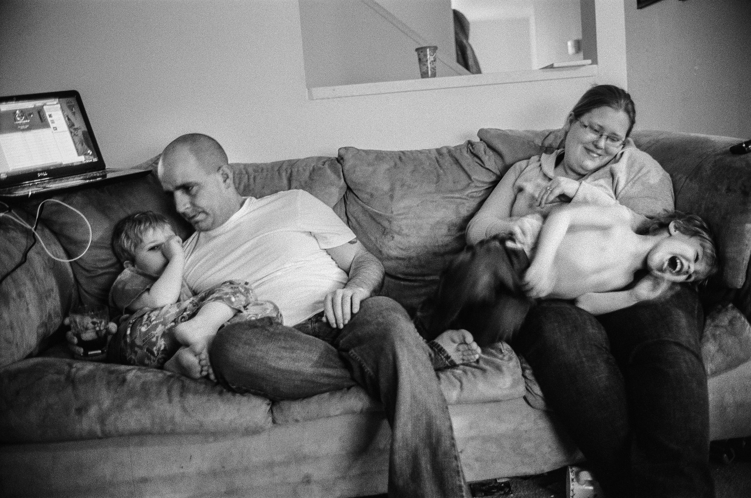 SPC Matthew Ledford sits at home with his wife, Scarlett, and their children at Fort Drum, New York, 2011. Ledford suffers from PTSD and anxiety. 