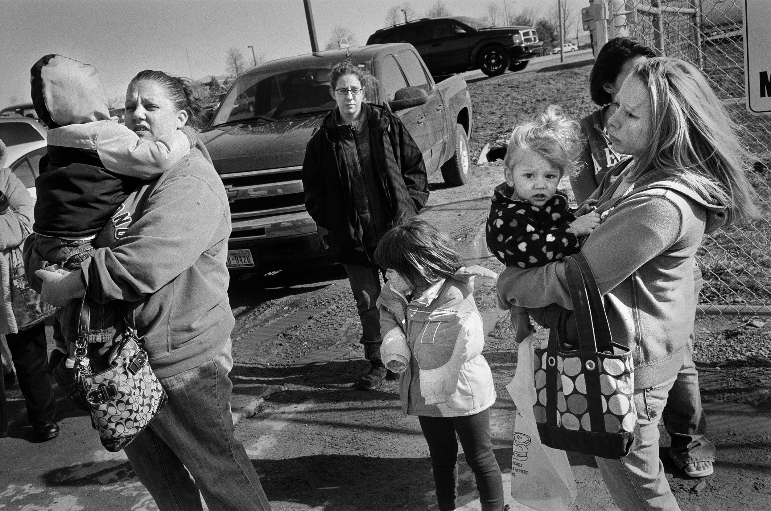  Wives and their children watch their husbands leave for Afghanistan at Fort Drum, New York, 2011. 