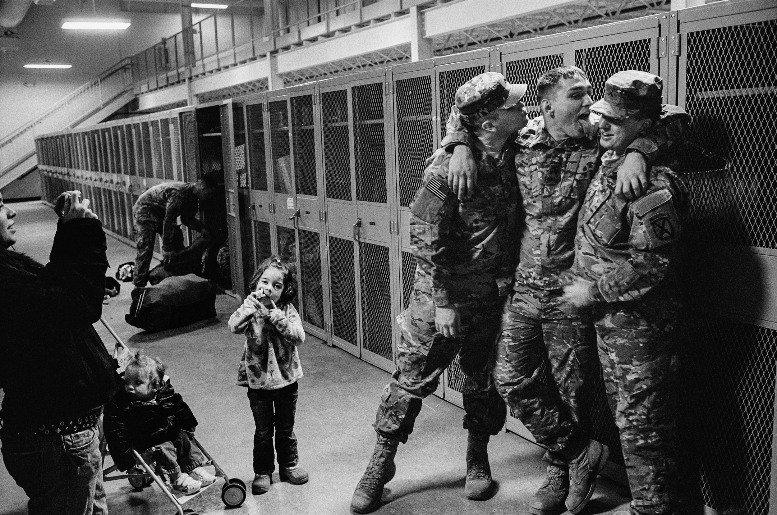 Soldiers pose for pictures before they deploy to Afghanistan at Fort Drum, New York, 2011.
