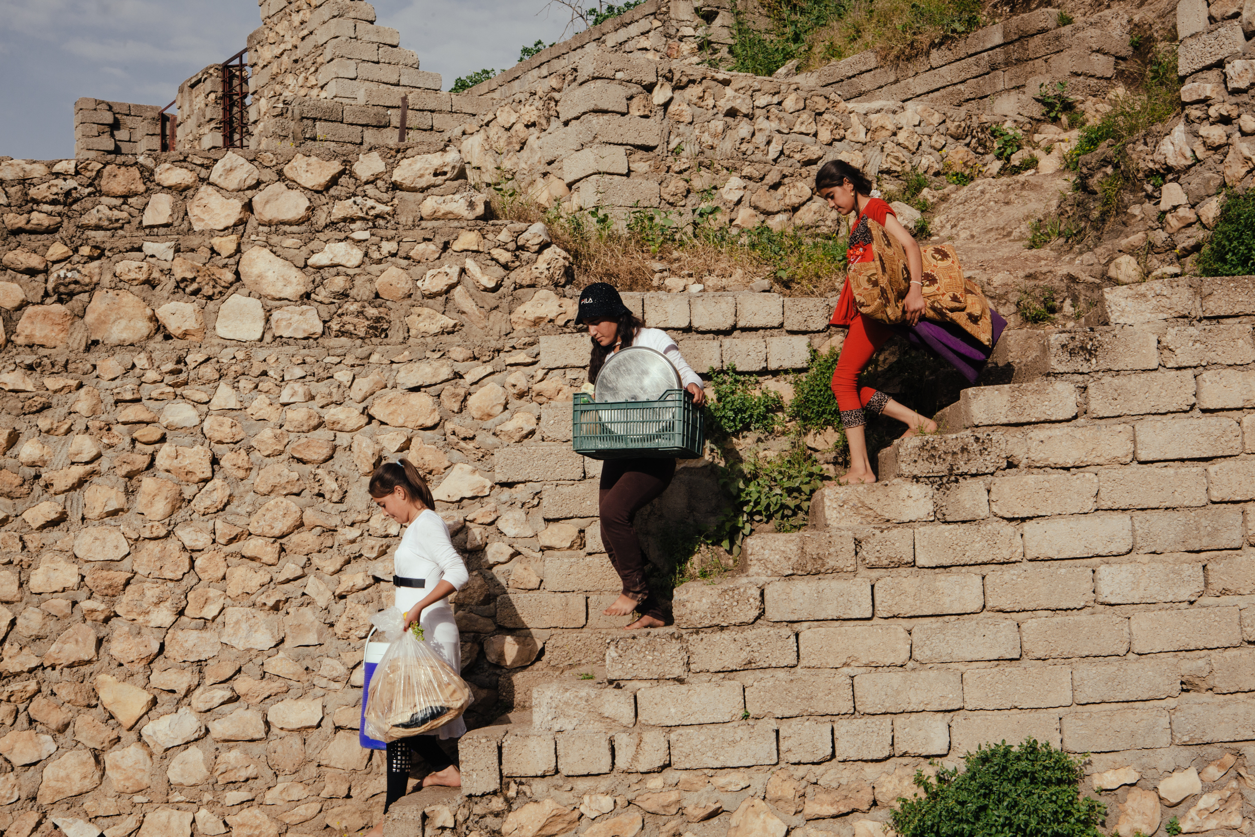  Girls carry food and other items down a staircase at Lalish, the most sacred and only Yezidi temple in the world,&nbsp;in Northern Iraqi Kurdistan.&nbsp; 