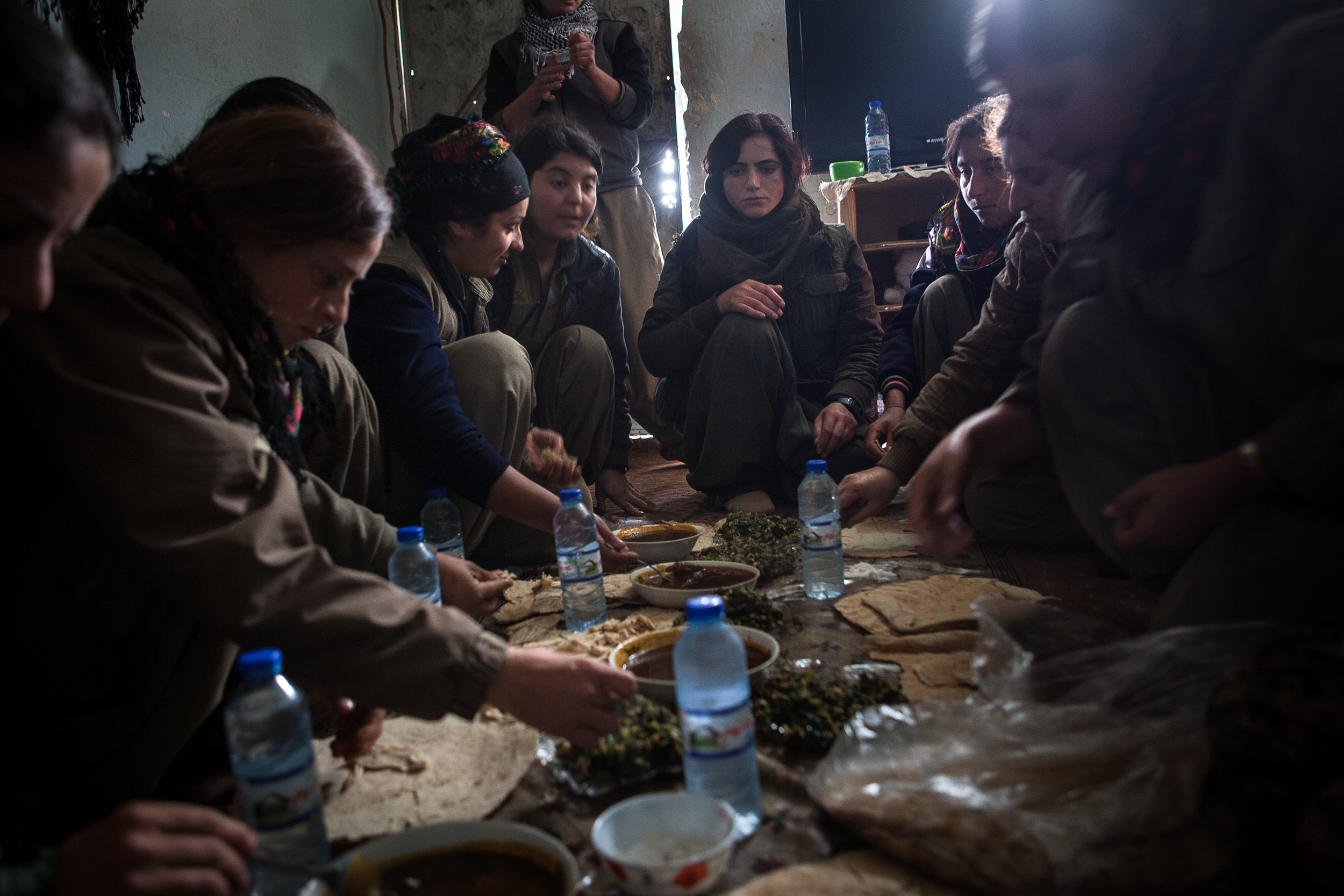  PKK guerrillas eat dinner at their post near Sinjar, Iraq.  