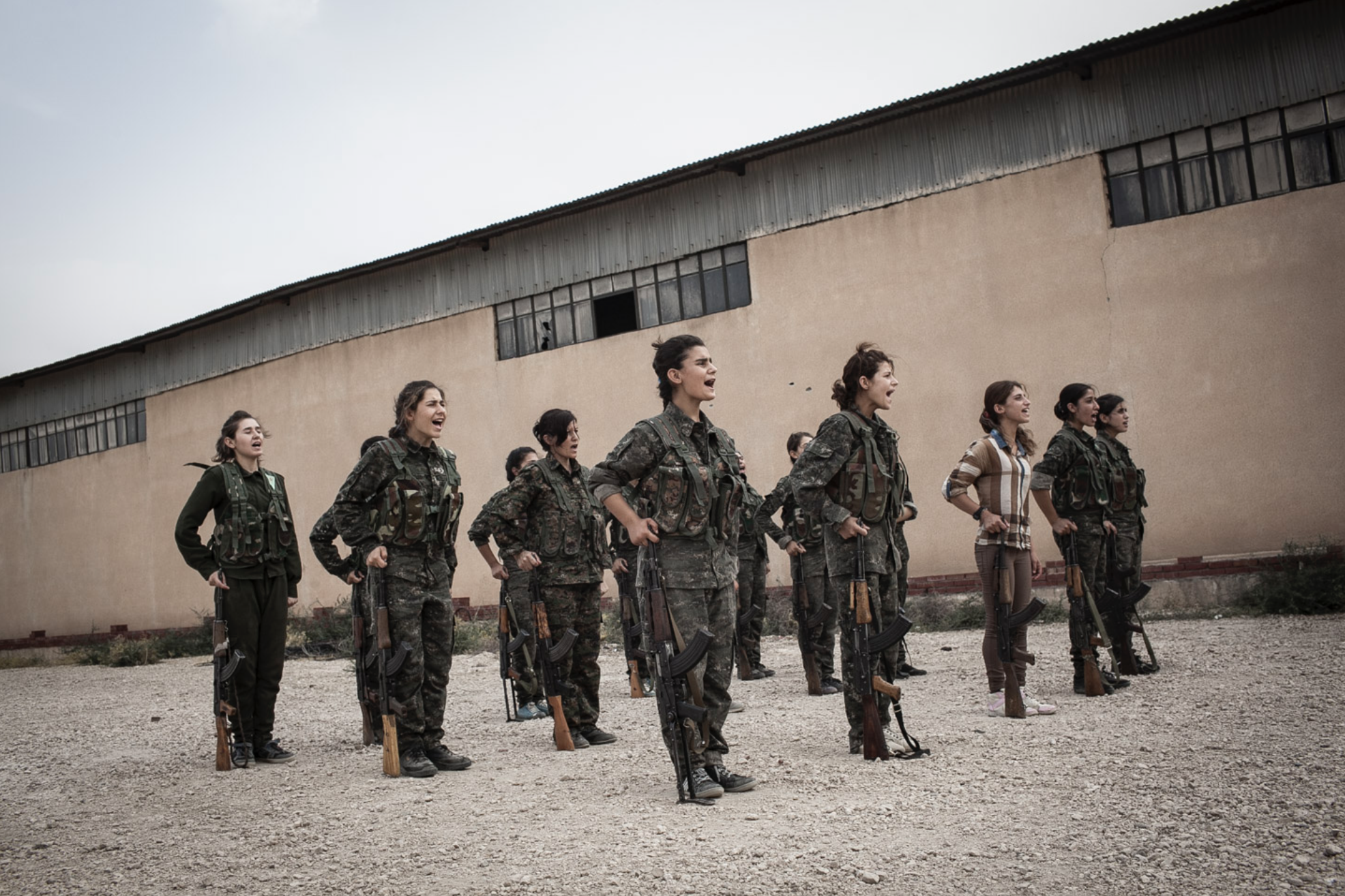  Young YPJ recruits participate in drills at dawn near Derek City, Syria. The YPJ schedule is demanding and discipline driven - new recruits get 6 hours of sleep and wake at 4 AM for physical training; afterwards, their day consists of drills and cla