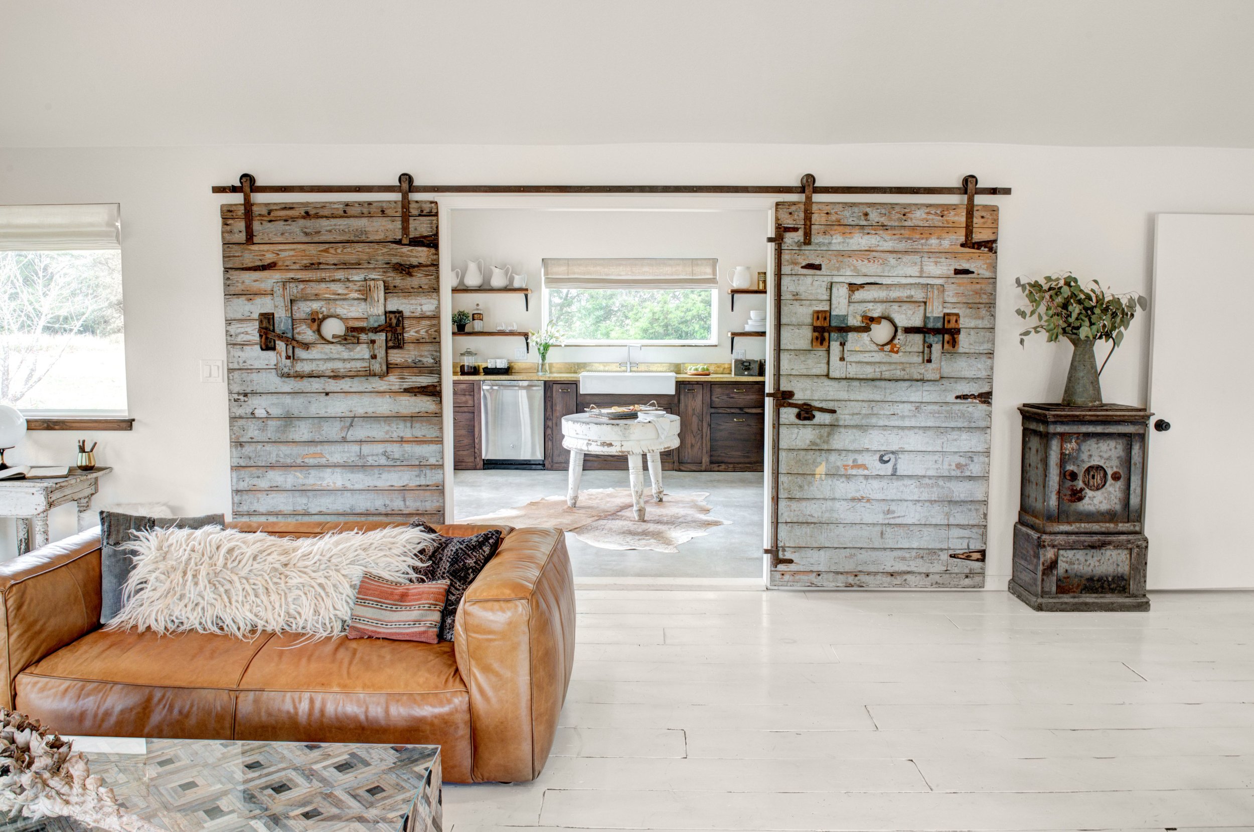   Reclaimed cotton gin doors separate the Boho kitchen from the great room.   