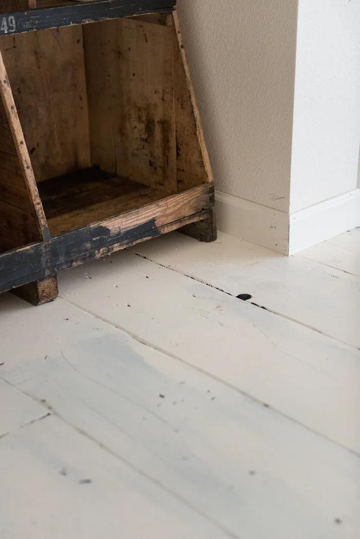 Martha Stewart Living’s ‘Pip’ in eggshell on the walls, semi-gloss on the baseboard, and high-gloss on the wood floor.