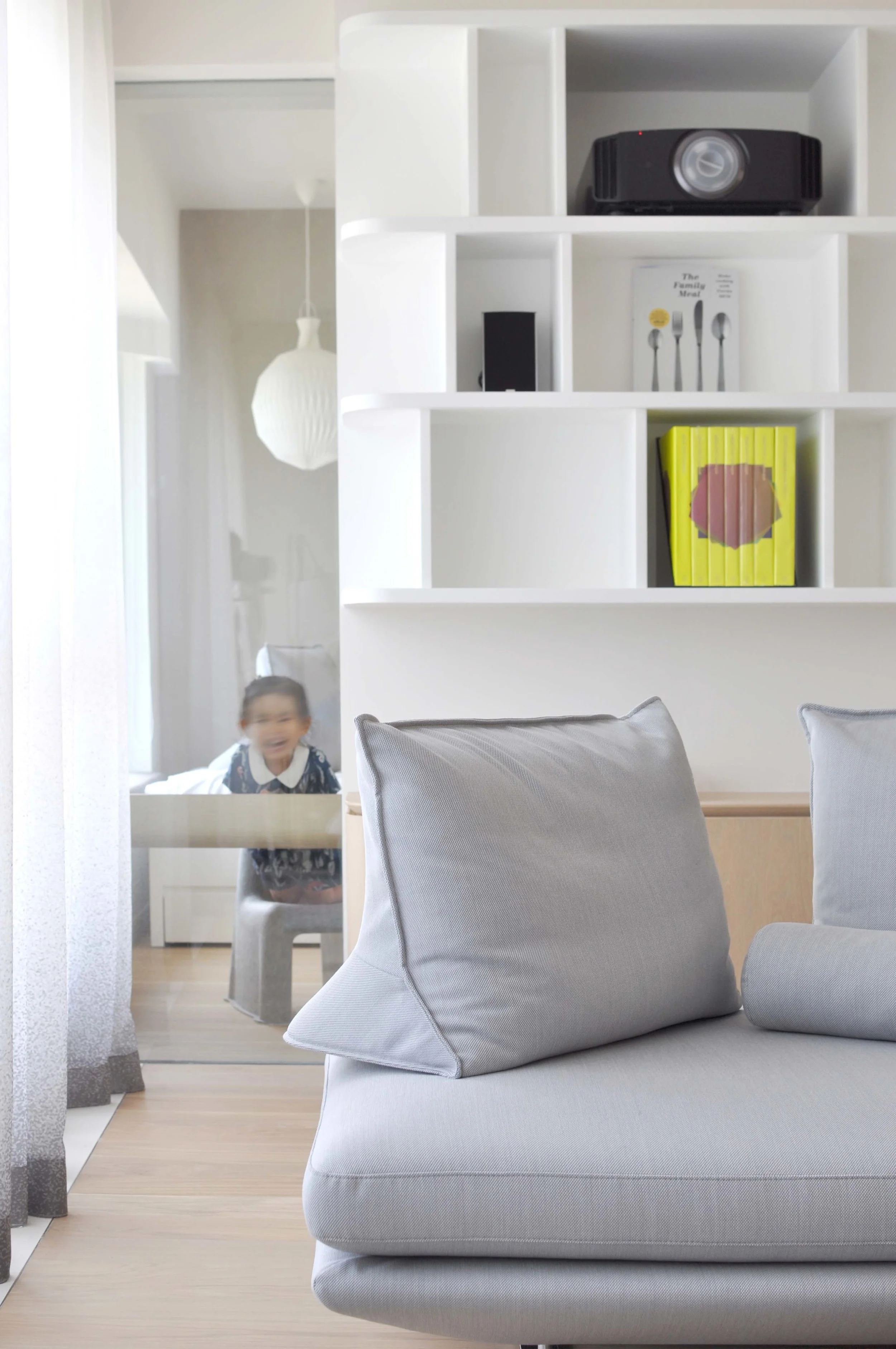The space was designed with children in mind, to encourage exploration of space though playing. Conceived with large wooden sliding doors, the children’s bedrooms can be fully opened onto the corridor with quirky handles, creating a large shared room for play. A series of glass interstices allow for playful peeking into the living spaces, while wall niches make for great hiding spots.