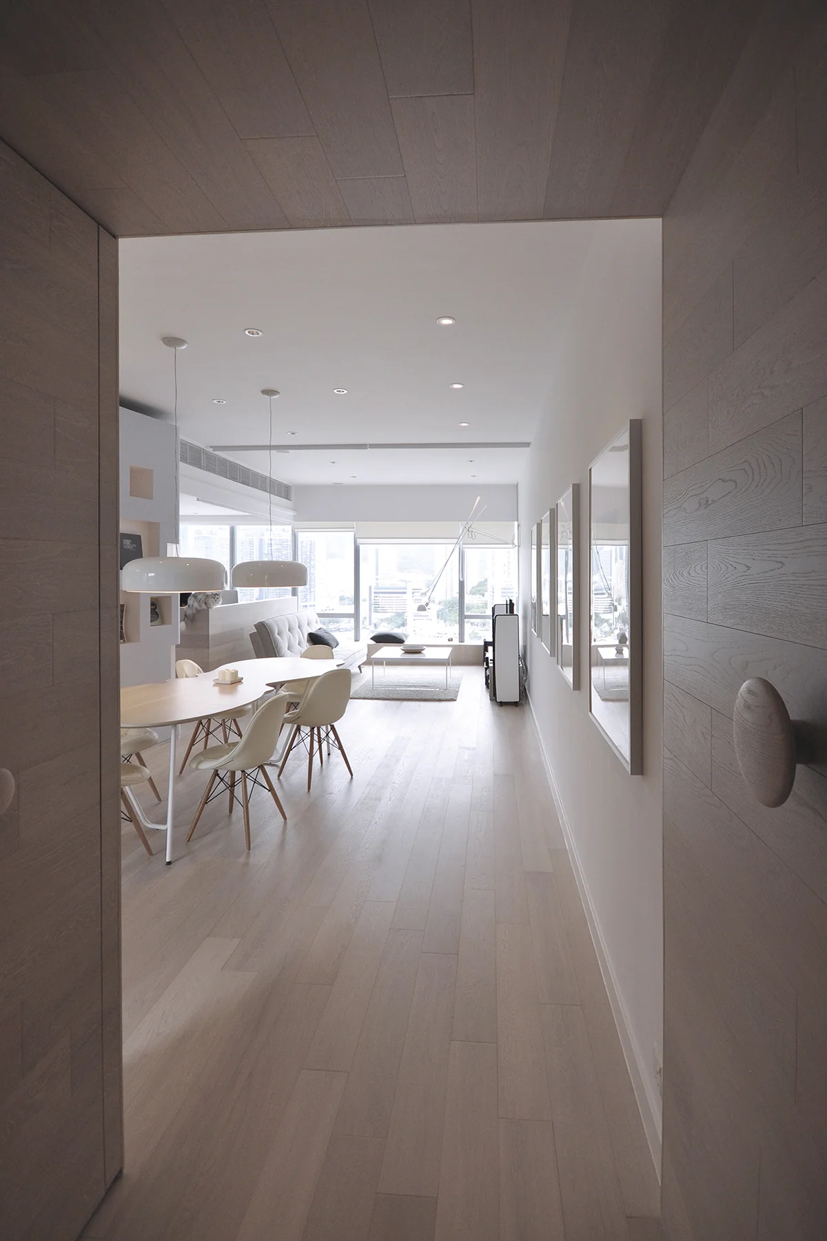The timber joinery surfaces were conceived as a ‘cat’s landscape’ that would rise and fall to provide a range of functions - wrapping the entry space with full height hidden storage doors, it then falls to seat-height along the panoramic windows to provide informal seating along the bay. Rising again as a half-height timber wall, it partitions the office and the lounge while preserving open panoramic views at eye level. The main ‘Bean Table’ is an extension of this landscape, and is lit by two large pendant lights – forming the centrepiece of the lounge. This bespoke CNC cut table shape is wiggly and playful, acting as a meeting table by day and dining table by night.