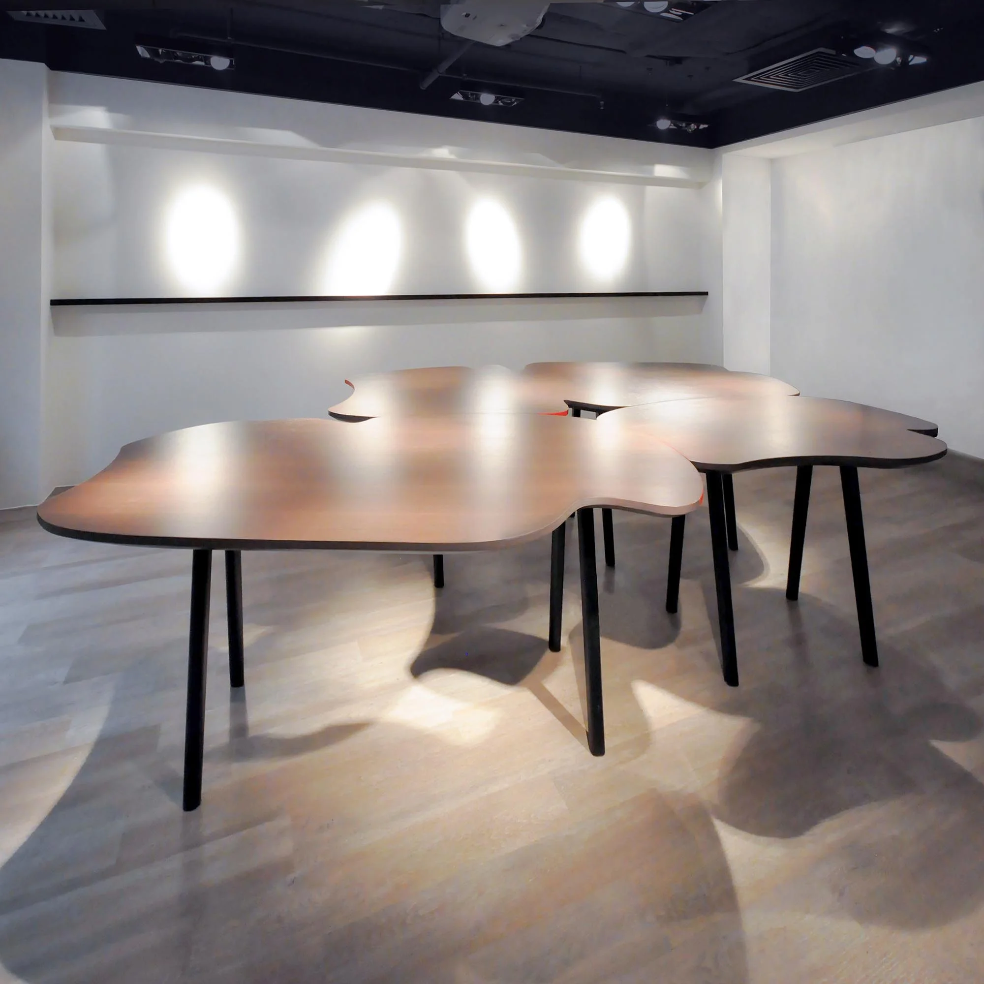 A set of wiggly and curvy conference tables was designed to break down the atmosphere of a traditional corporate conference room. These tables can be playfully re-arranged into four configurations to adapt to different scenarios - from one long table for large-scale meeting, to smaller clusters for small-scale meetings — a reminder of the state of flux as the key to creativity. 