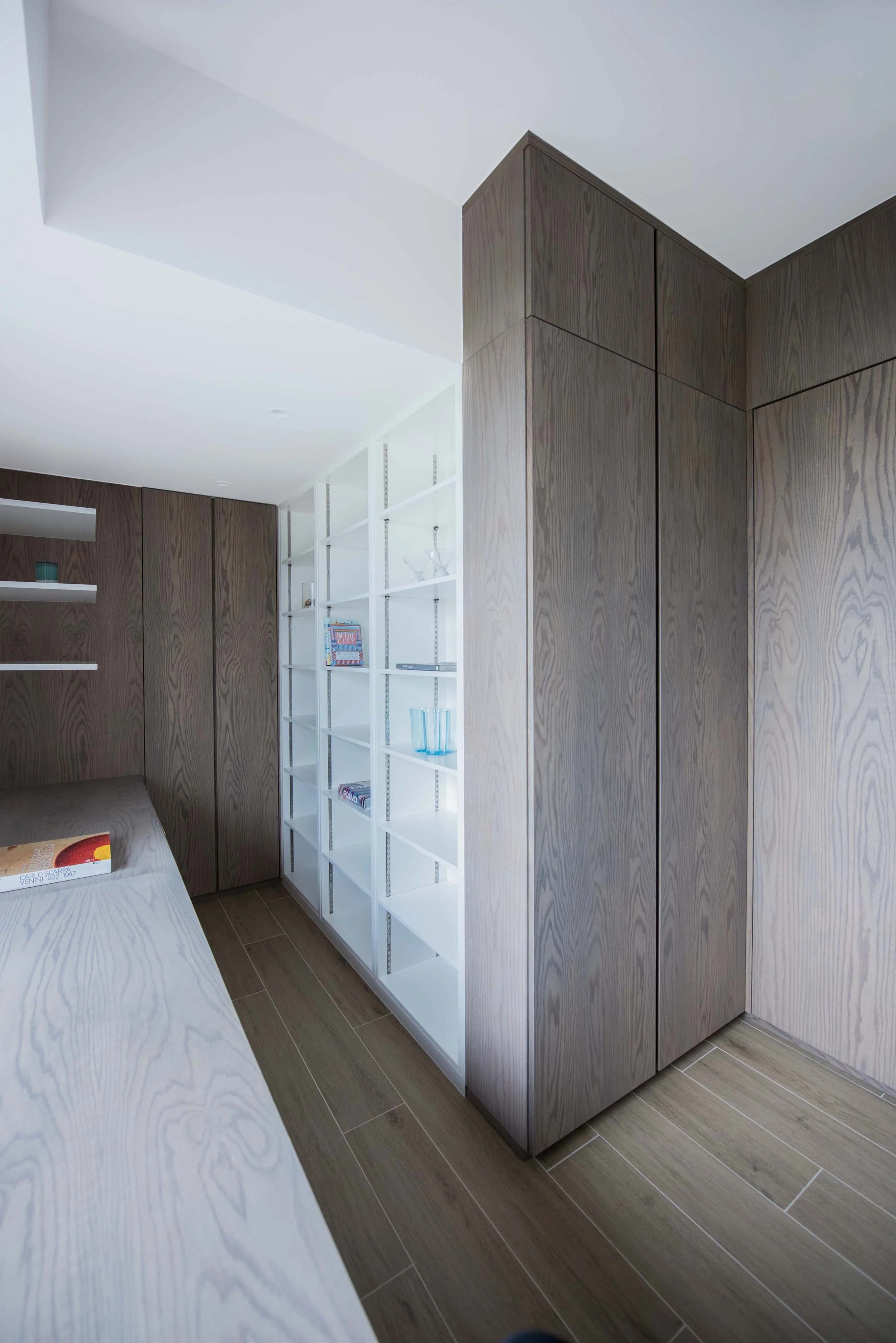 The study room has high density storage for books and filing, as well as a bespoke built in desk with cable management for computer and printers. A magnetic writable surface is integrated into the white walls of the room.