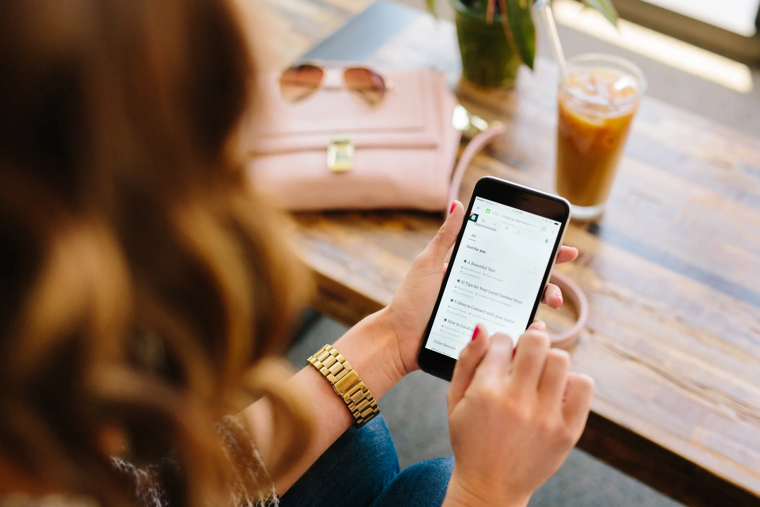 using phone to work at coffee shop
