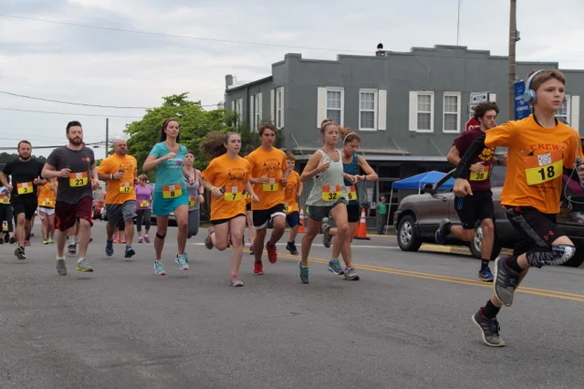 Participants running in the Crewe Homecoming Festival 5K run organized by the local volunteer fire department.