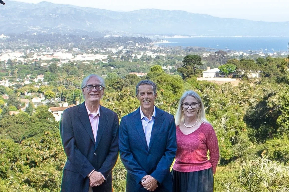 photo of Mark Watson, Michael Parsons and Elizabeth Hanning-Yu with view of Santa Barbara city, mountains and harbor beyond.