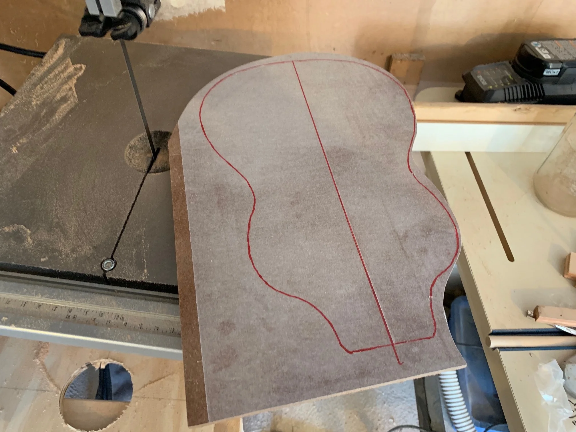 The next step is to glue the traced design onto your MDF (I use 3M super45 adhesive) and rough cut it out on the band saw.