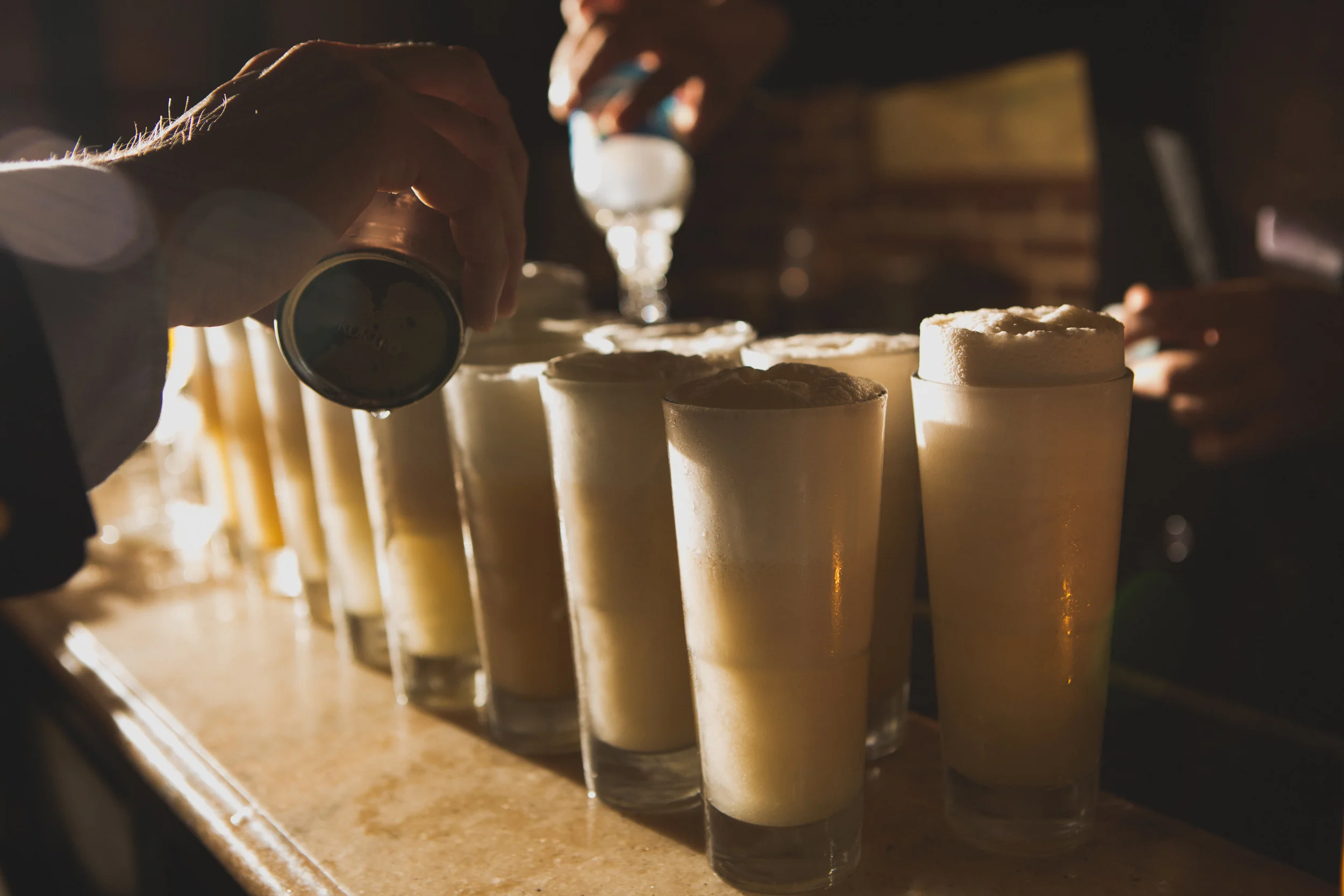 A gaggle of Ramos Gin Fizzes as prepared by Principal Barkeep Maxwell Britten and his team