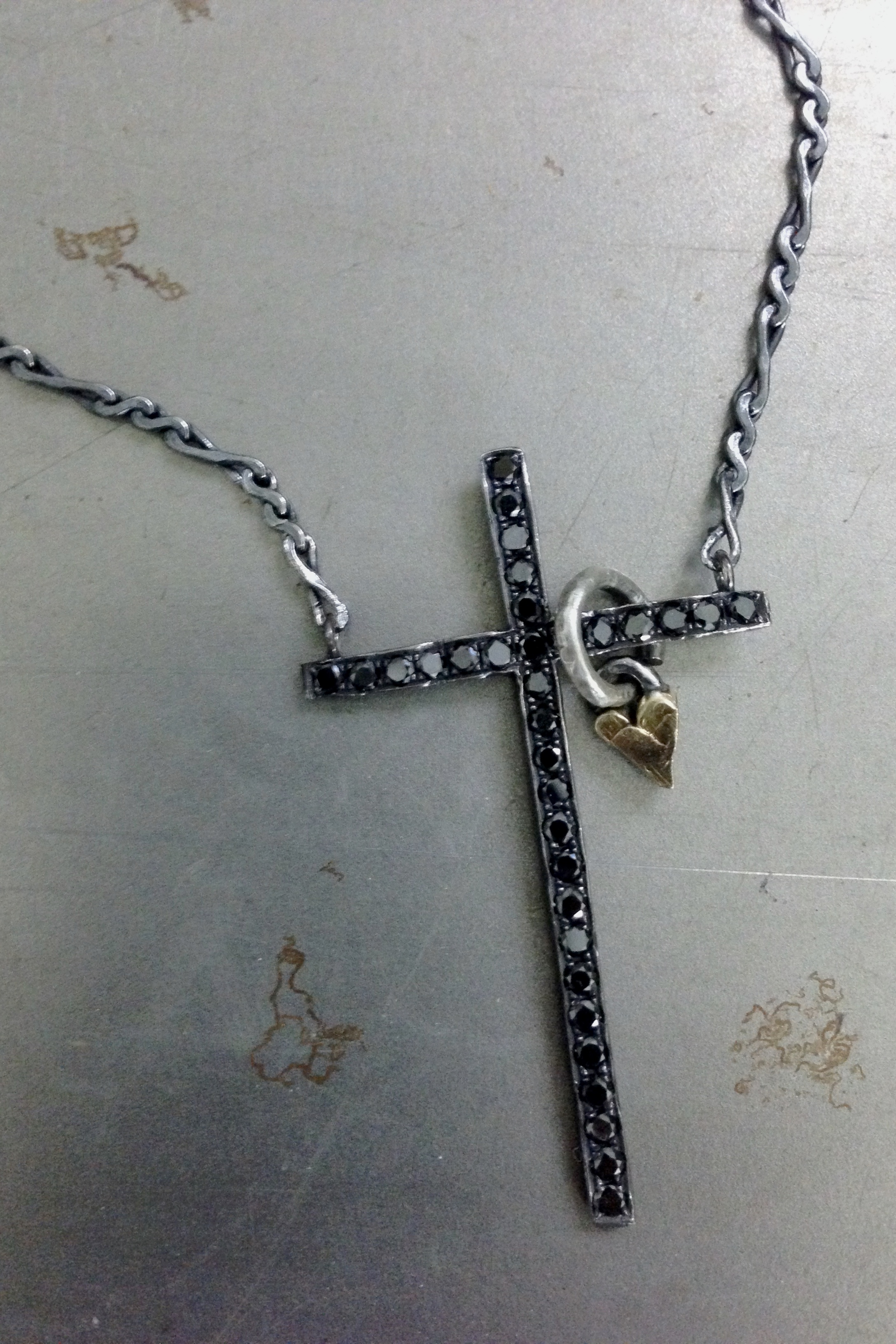 black diamond cross and gold heart nugget pendants