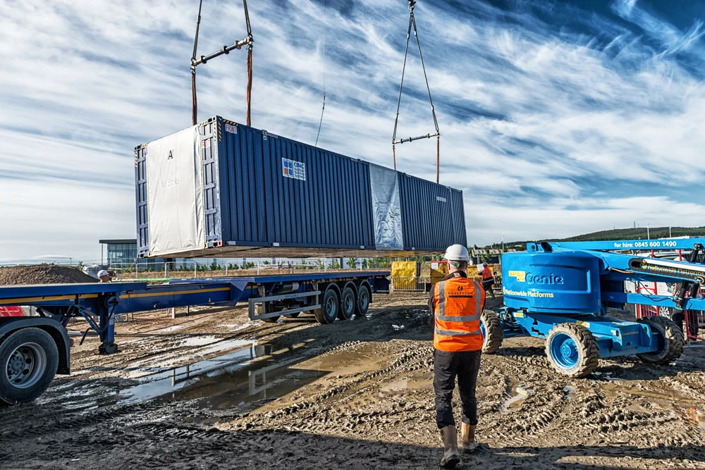 Lifting a unit from its transporter.