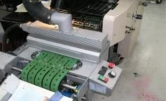 PRIME UV's UV Conveyor System curing in-line with a Ryobi Sheetfed Press.