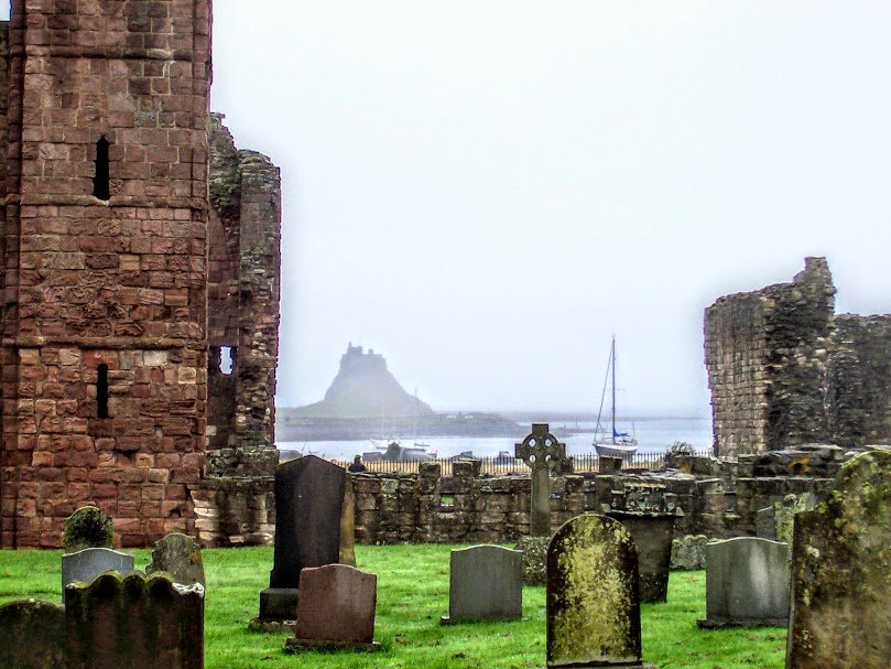 Ruins of Lindisfarne Abbey with Castle in background