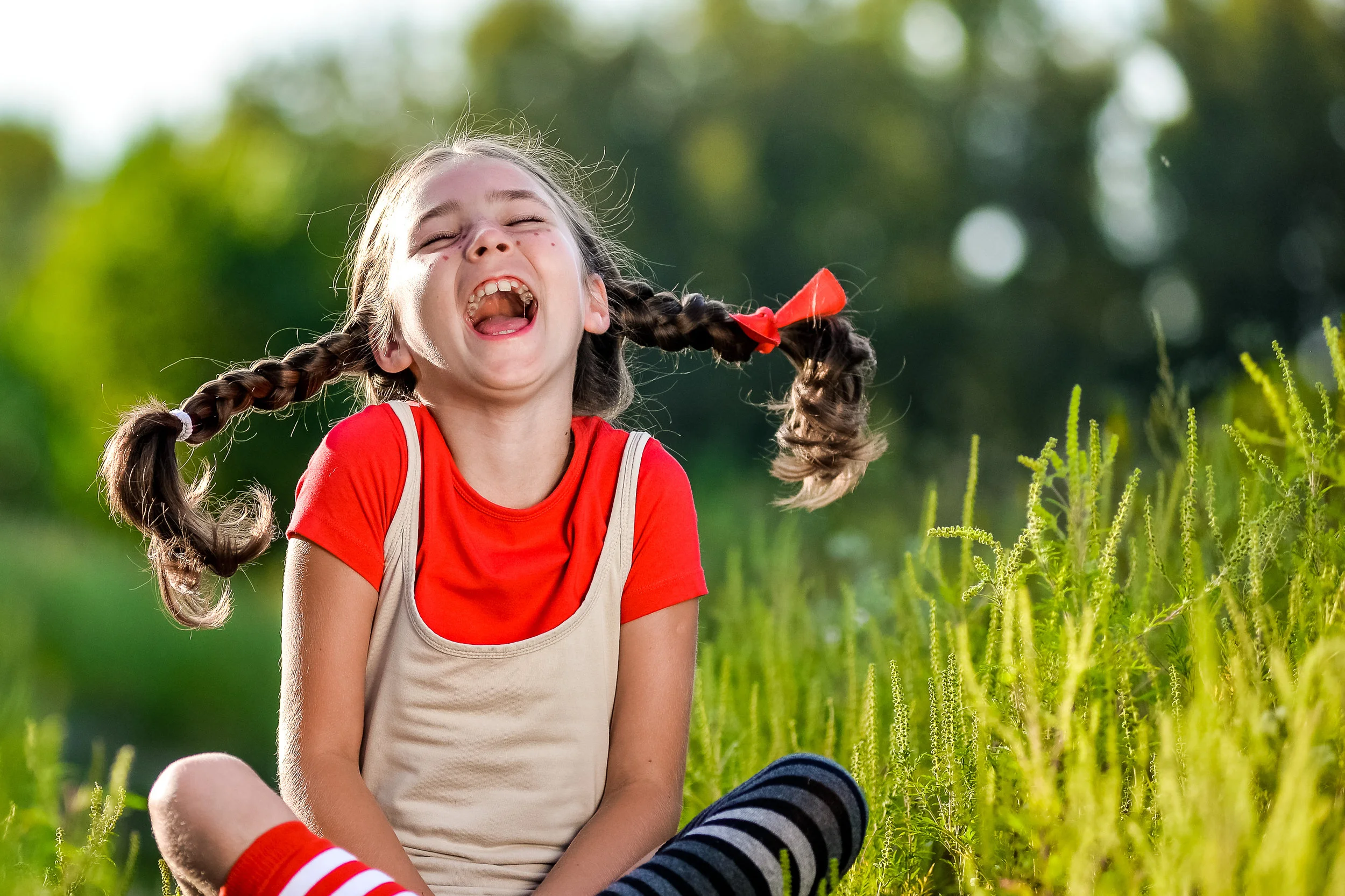 naughty girl with pigtails, opens his mouth and shouts
