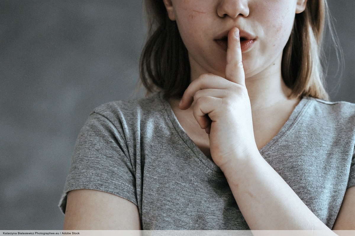 Girl with finger on mouth