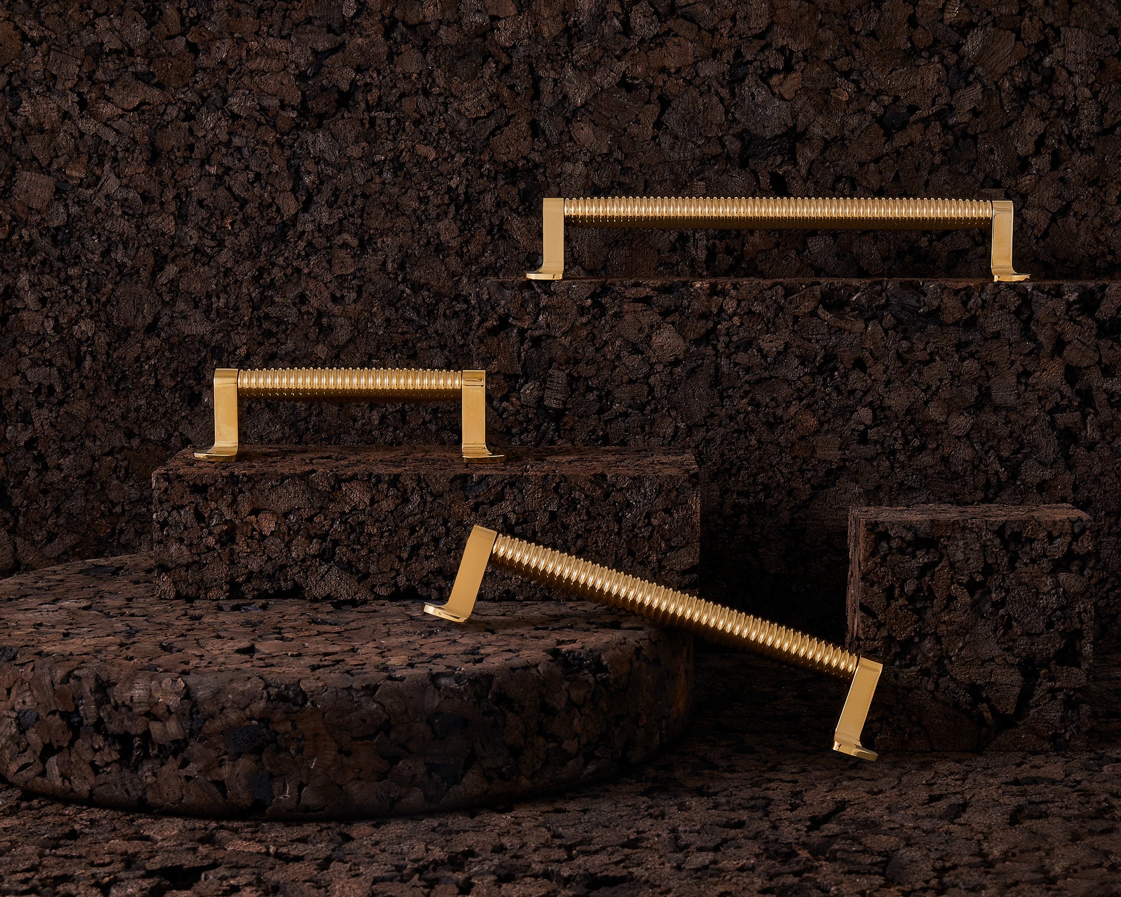 O&G-CAISSON GROUP - POLISHED BRASS ON CORK.jpg