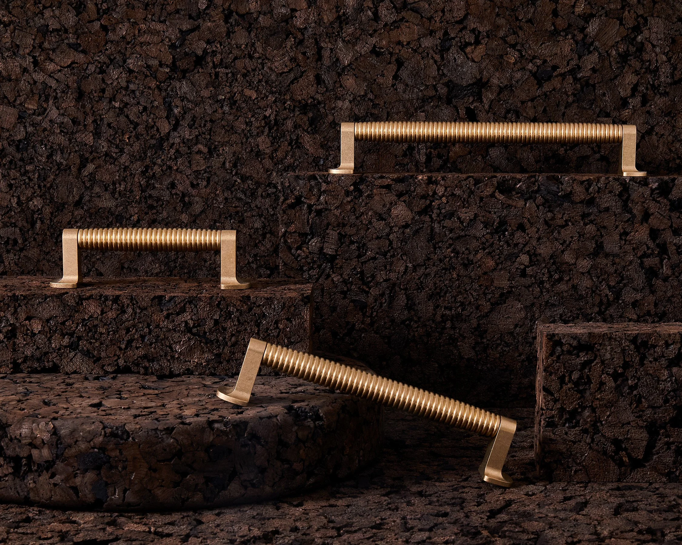 O&G-CAISSON GROUP - TUMBLED BRASS ON CORK.jpg